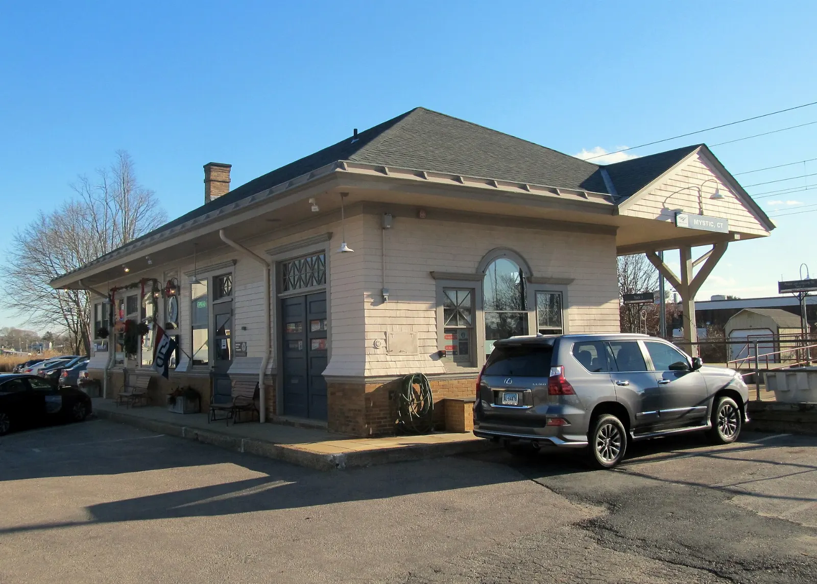 The historic Mystic railroad station building beside the tracks, Connecticut