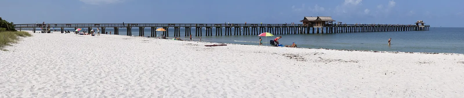 The long wooden Naples Pier stretching from the beach into the Gulf of Mexico, Florida