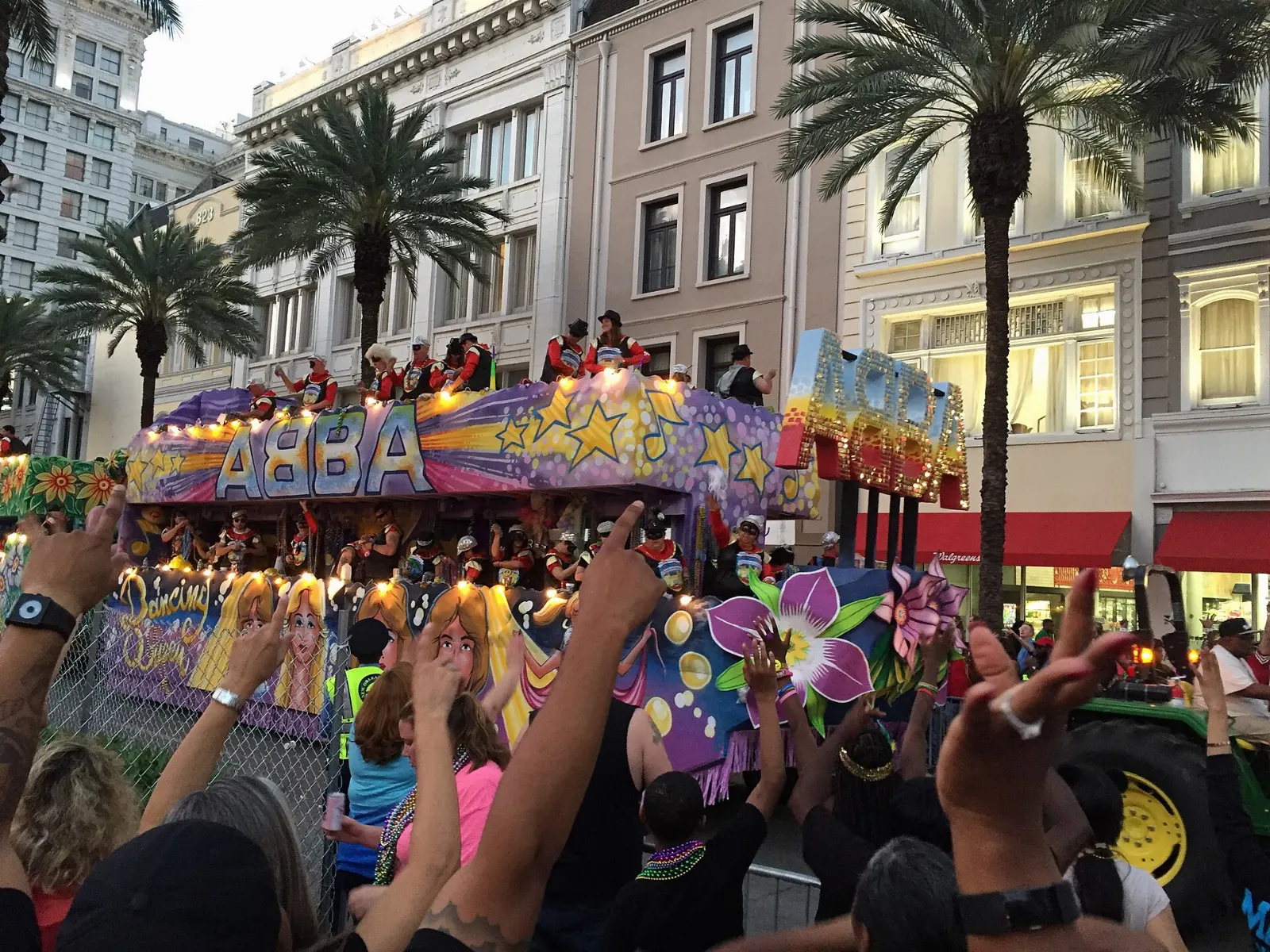 A brightly decorated Mardi Gras float with riders throwing beads to the crowd, New Orleans, Louisiana