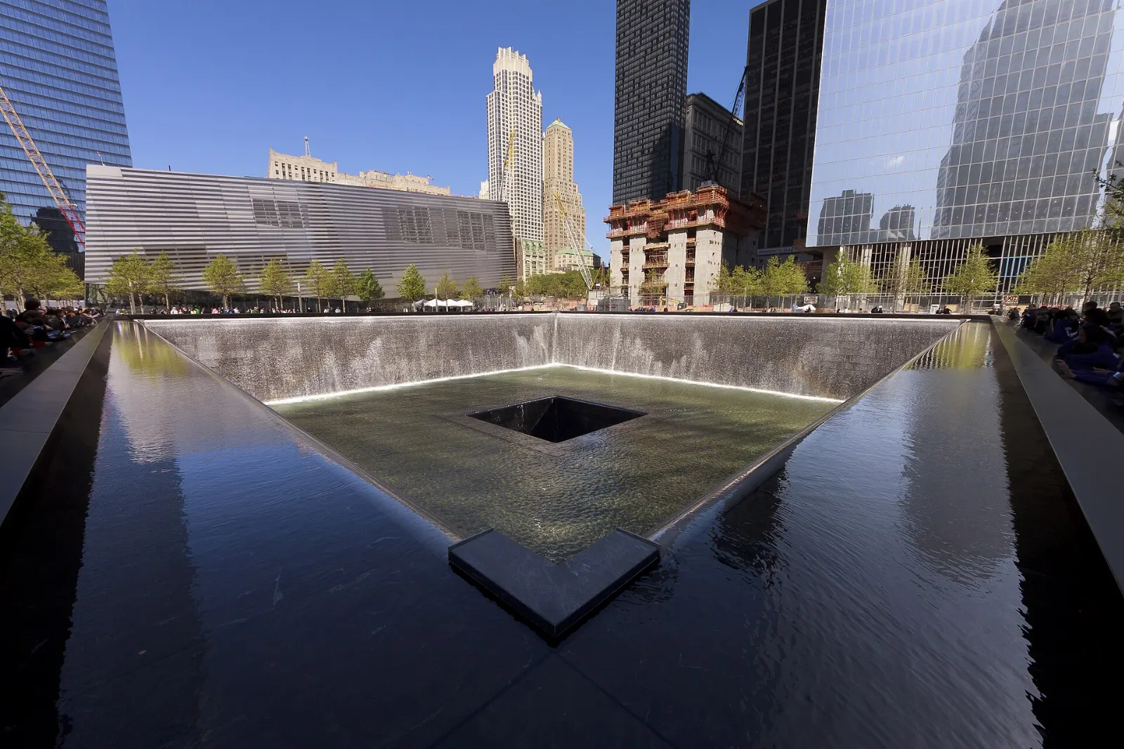 Square reflecting pool with waterfalls and bronze name panels at the 9/11 Memorial, New York City, New York