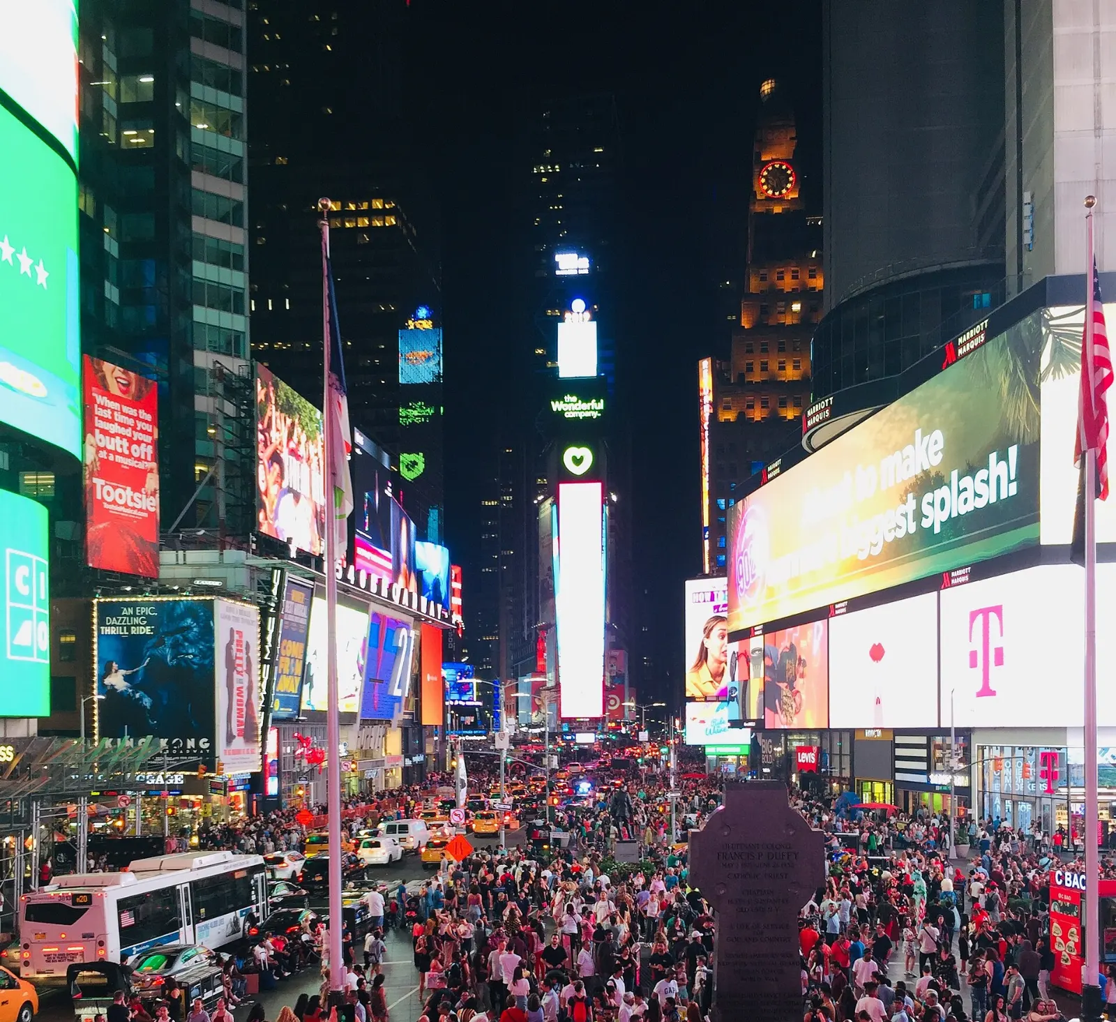 Times Square at night filled with giant illuminated billboards and crowds, New York City, New York