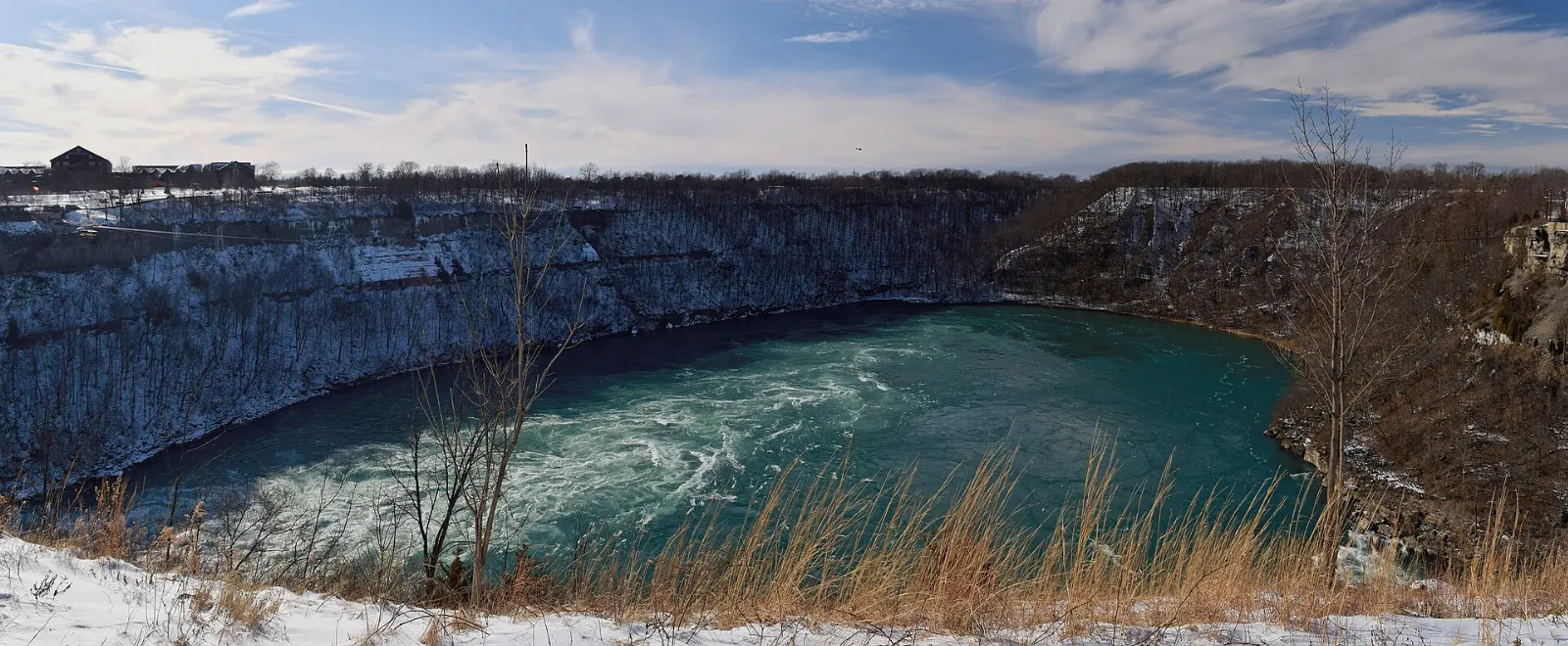 The swirling Niagara Whirlpool far below the wooded walls of the gorge, Niagara Falls, New York