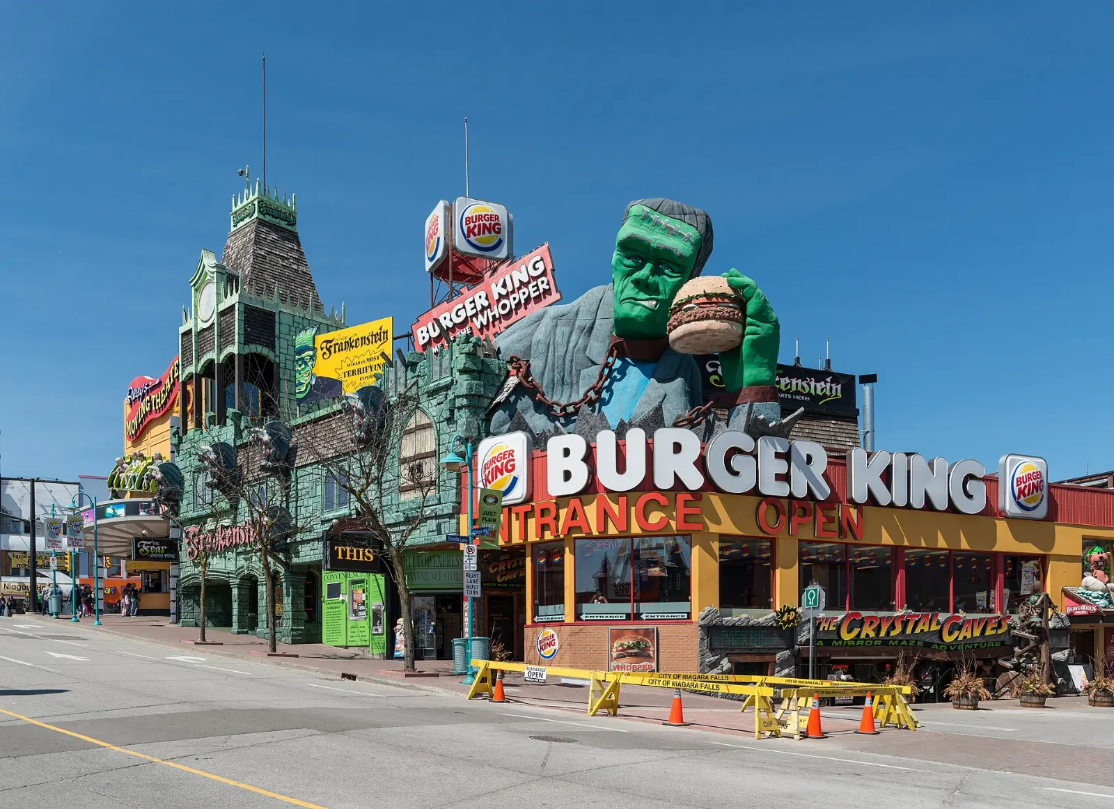 Clifton Hill street lined with attractions and lit signs at dusk, Niagara Falls, Ontario