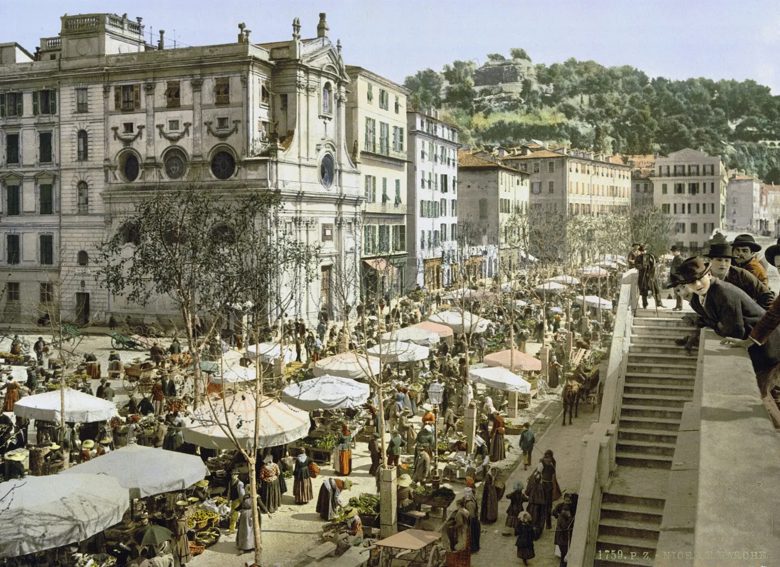 Market stalls with striped awnings selling flowers and produce on the Cours Saleya in Nice, Nice and the French Riviera, France