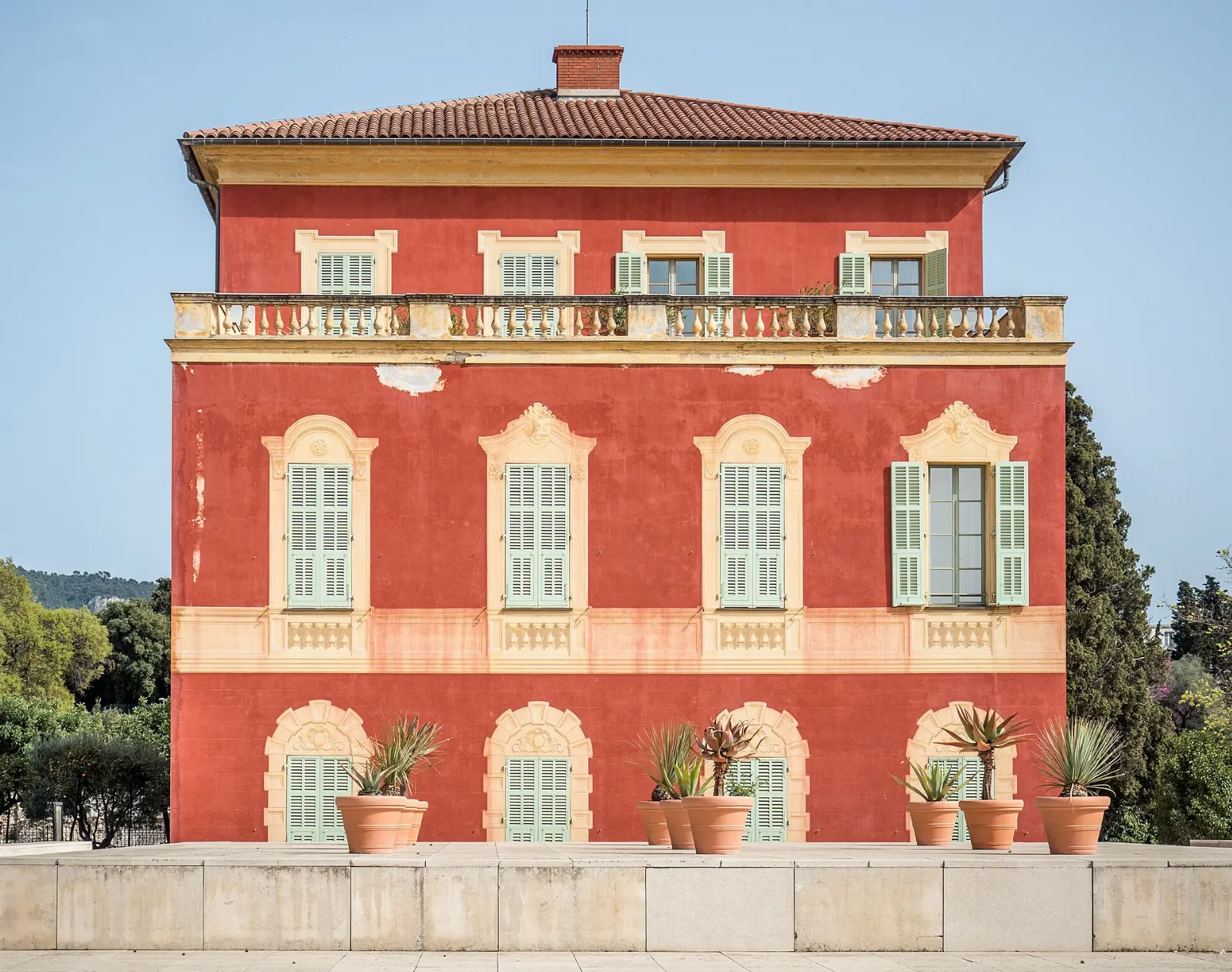 Red ochre Genoese-style villa housing the Matisse Museum among olive trees in Cimiez, Nice and the French Riviera, France