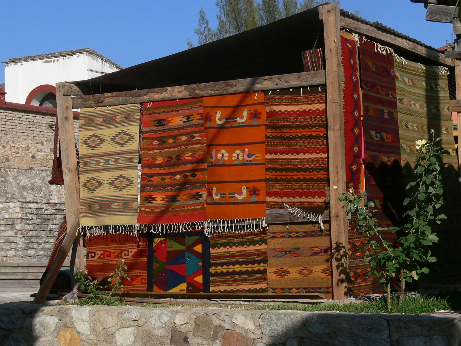 Handwoven wool rugs with Zapotec patterns hanging in Teotitlán del Valle, Oaxaca, Mexico
