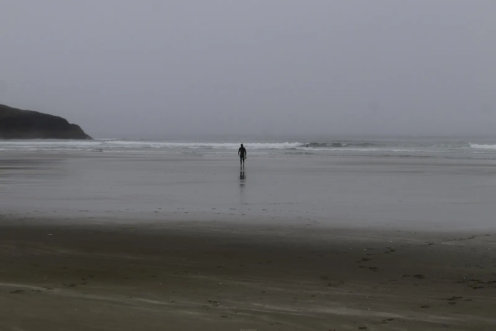 Surfers in the waves at Long Beach near Tofino, Pacific Rim National Park Reserve, British Columbia
