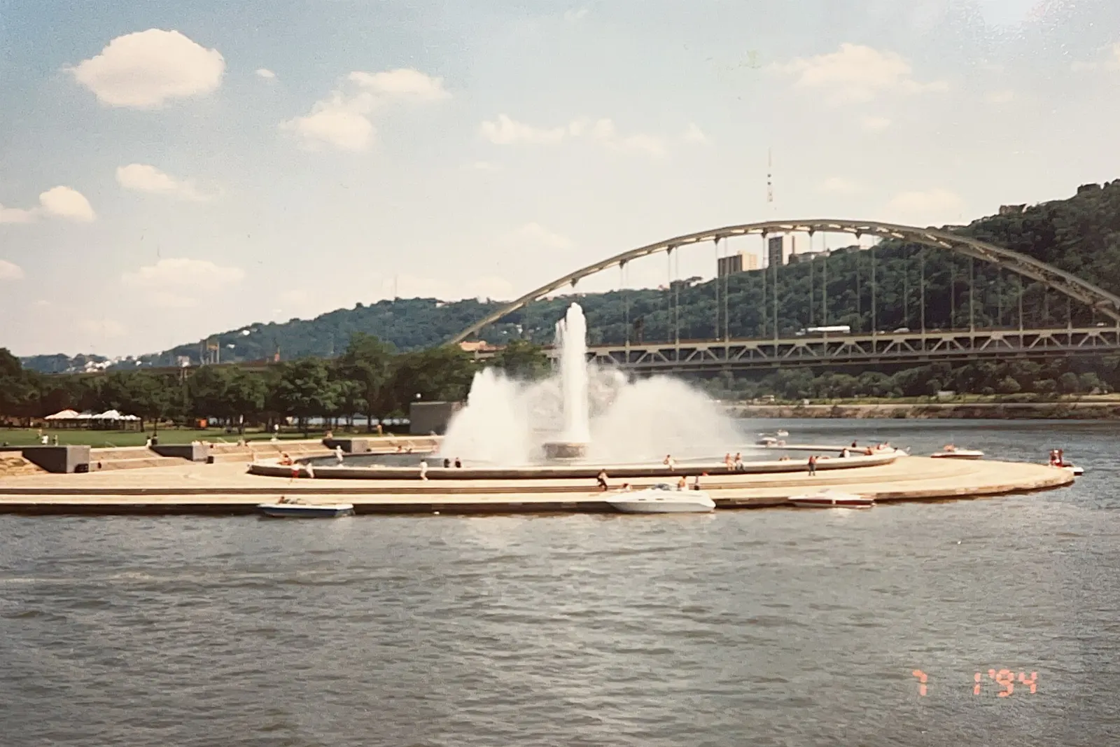 A large fountain spraying water high into the air at the tip of a park where rivers meet, Pittsburgh, Pennsylvania