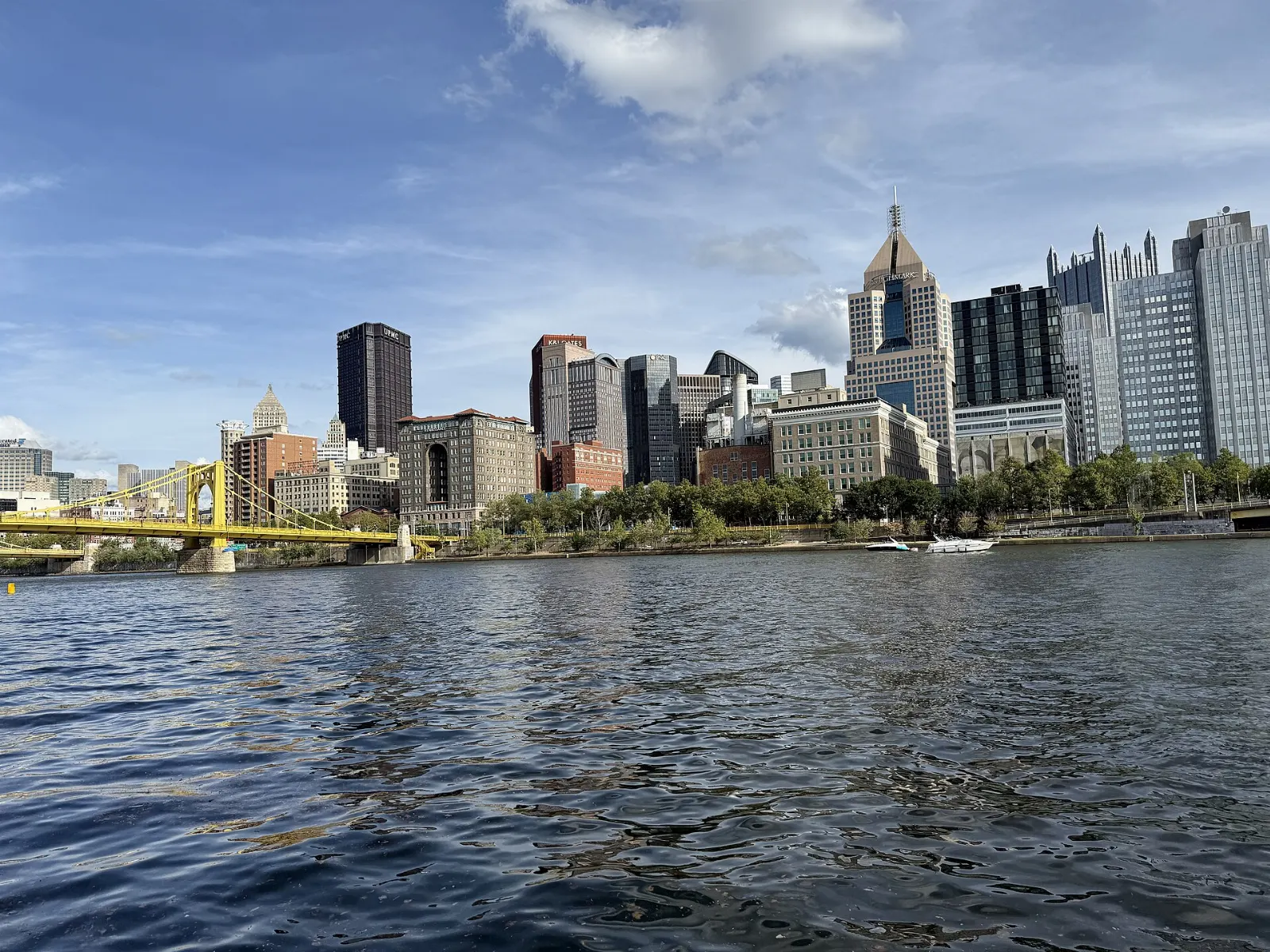 A baseball stadium on a riverbank with a yellow bridge and the downtown skyline beyond, Pittsburgh, Pennsylvania