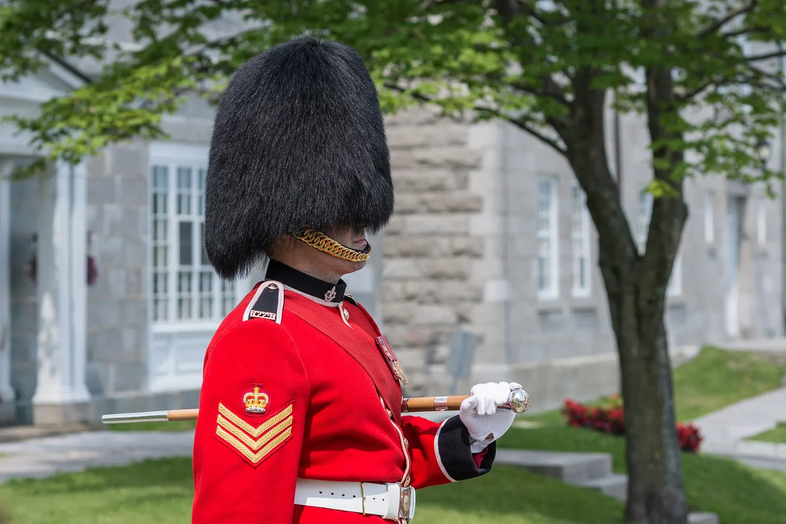Soldiers in red tunics and bearskin hats parading inside the Citadelle of Quebec, Quebec City, Canada
