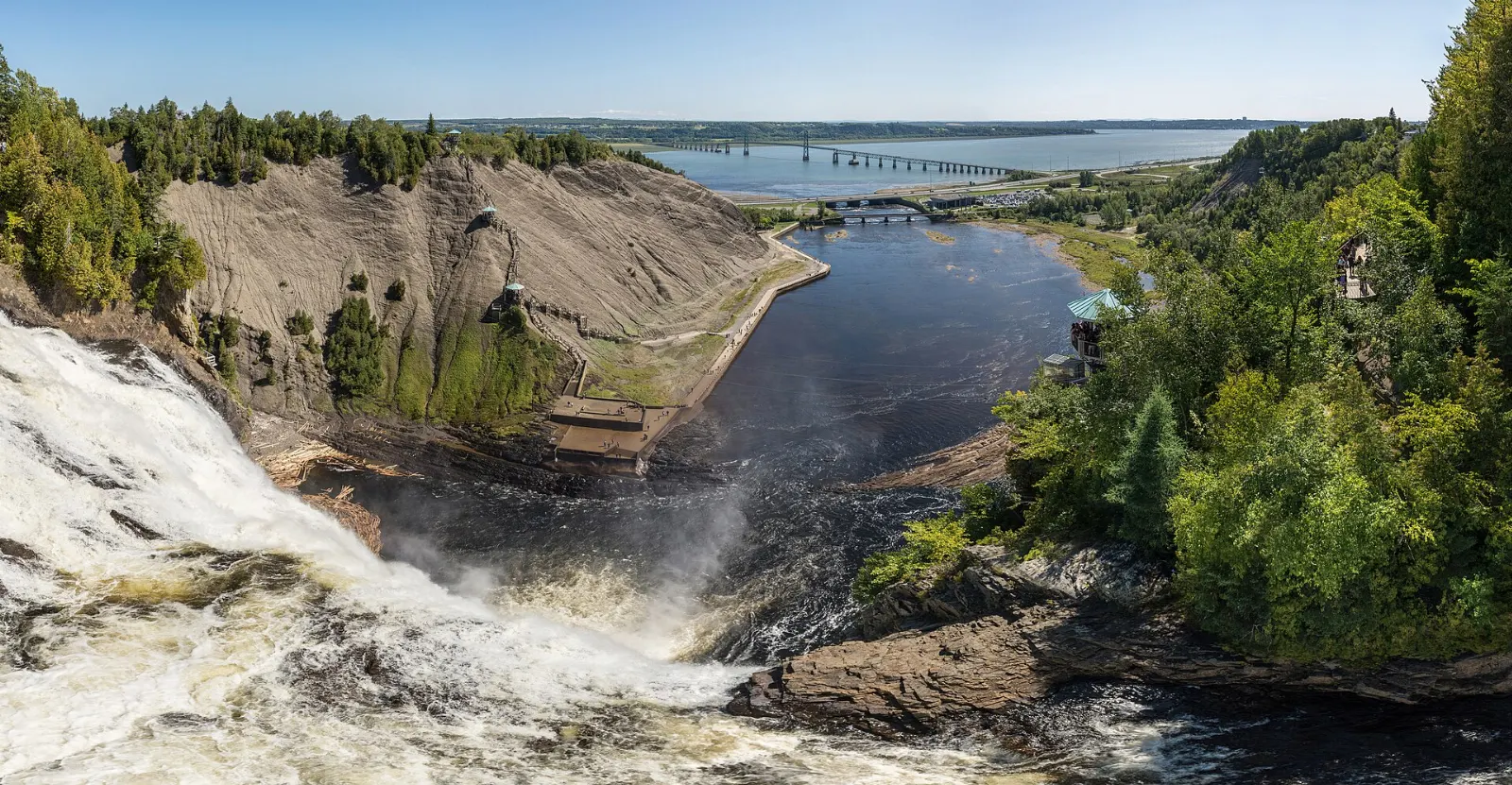 Montmorency Falls plunging over a cliff with a suspension bridge across its crest, Quebec City, Canada