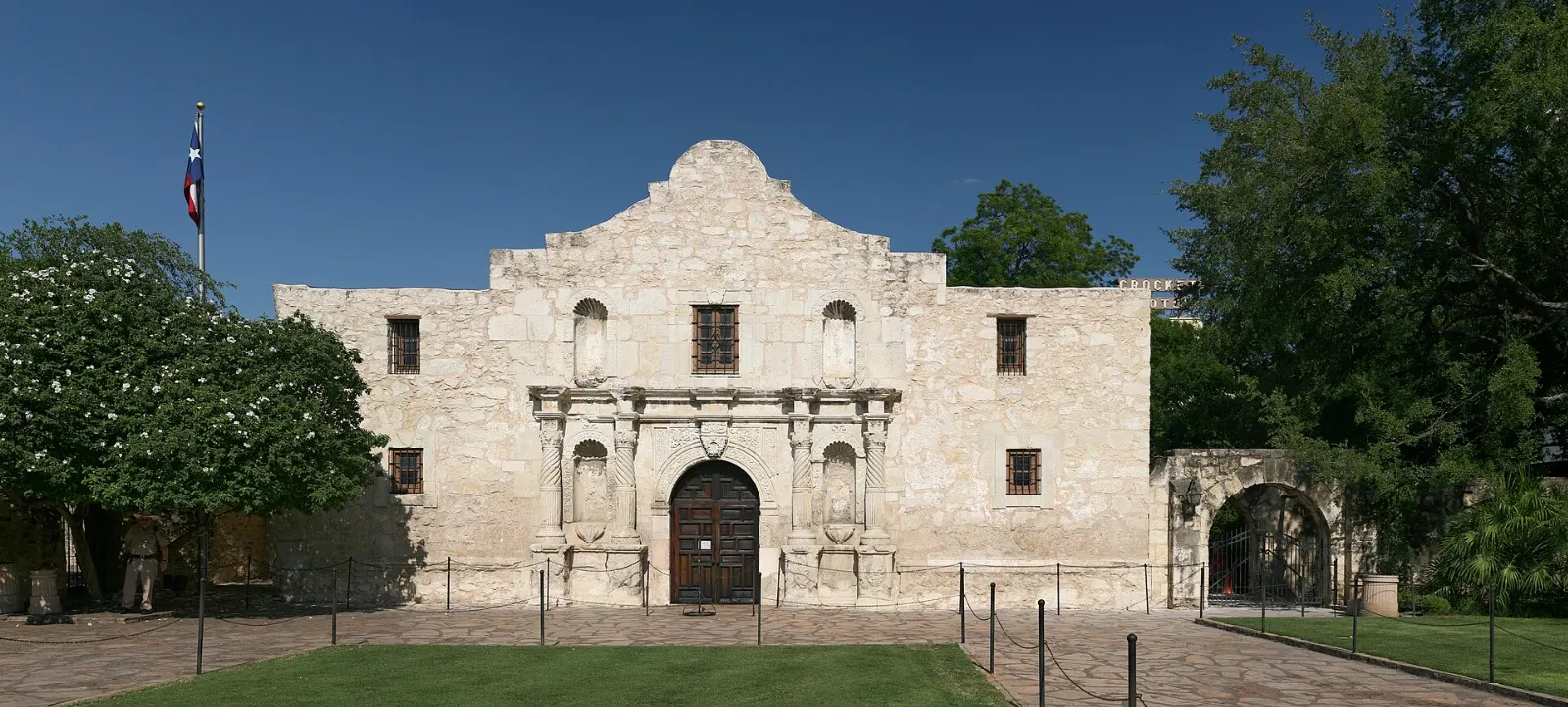 Limestone facade of the Alamo church with its curved parapet on Alamo Plaza, San Antonio, Texas