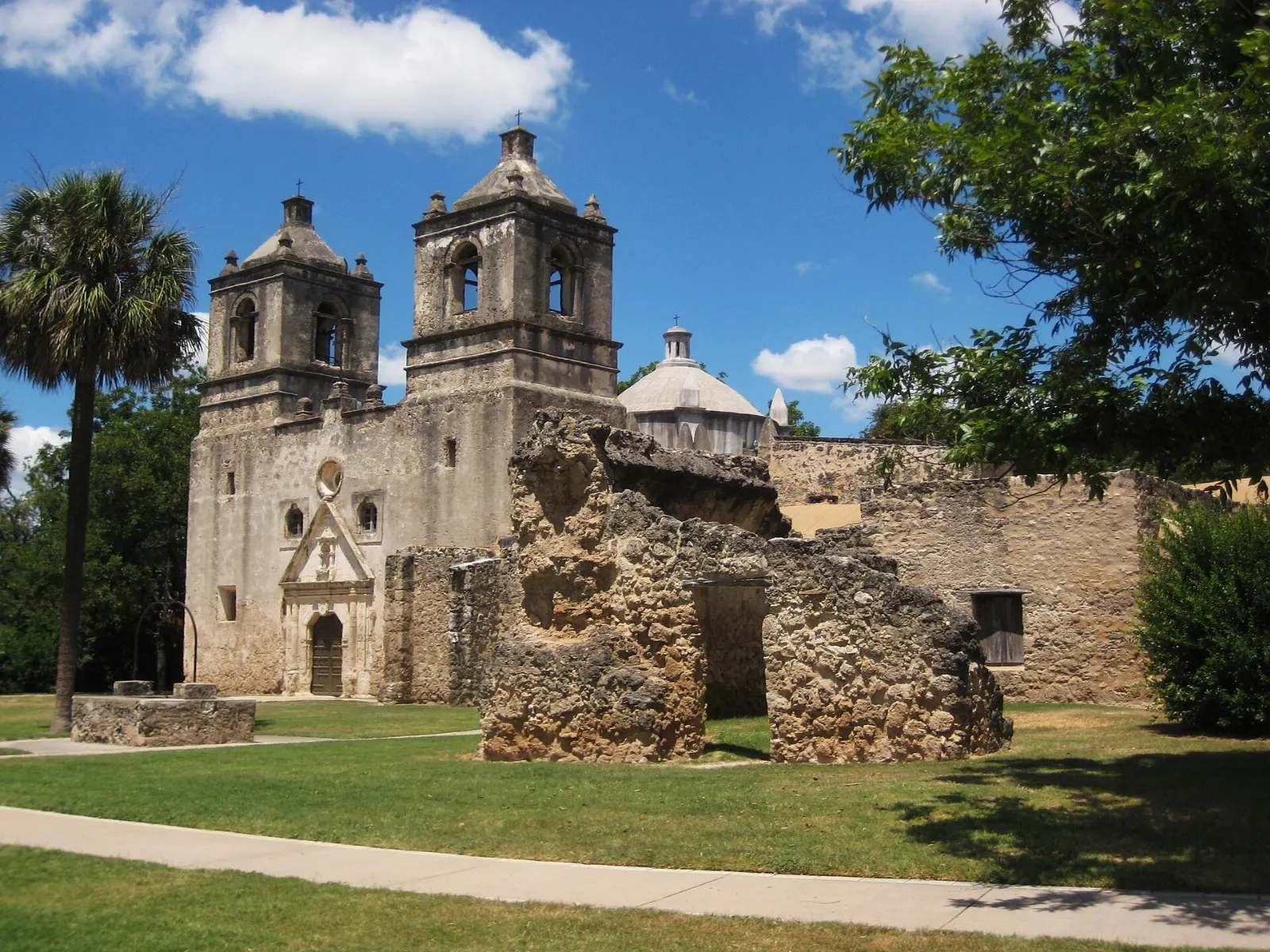 Twin bell towers and dome of Mission Concepcion under a blue sky, San Antonio, Texas