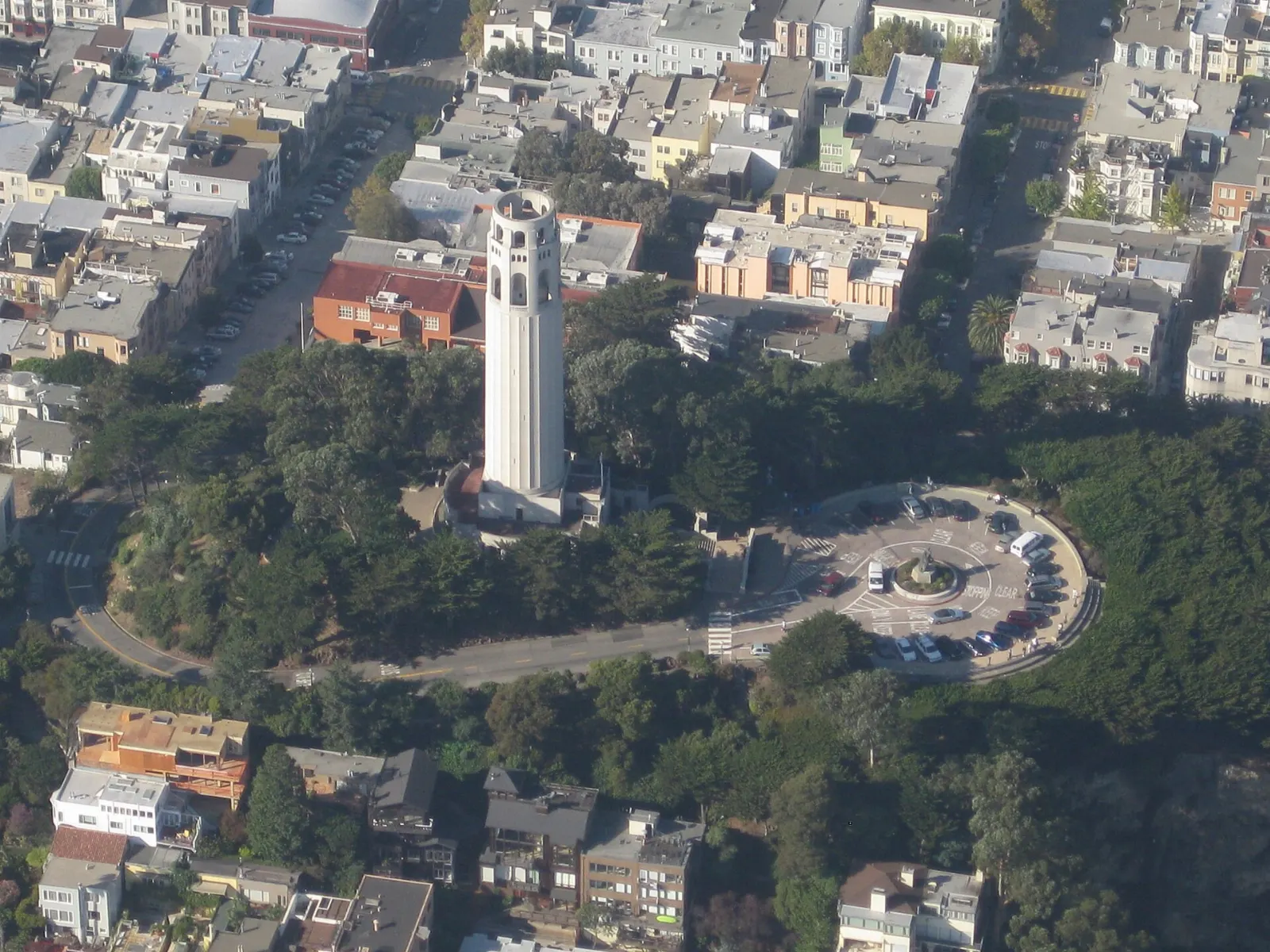 The white concrete Coit Tower rising above the trees on Telegraph Hill, San Francisco, California