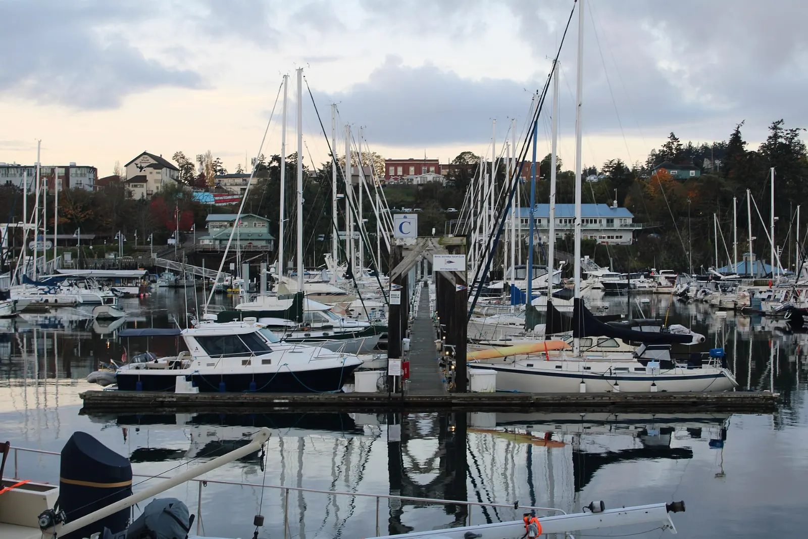 Boats moored in the marina at Friday Harbor with the town on the hillside behind, San Juan Islands, Washington