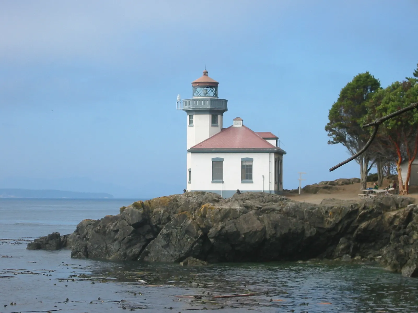 White lighthouse on a rocky shoreline above Haro Strait at Lime Kiln Point, San Juan Islands, Washington