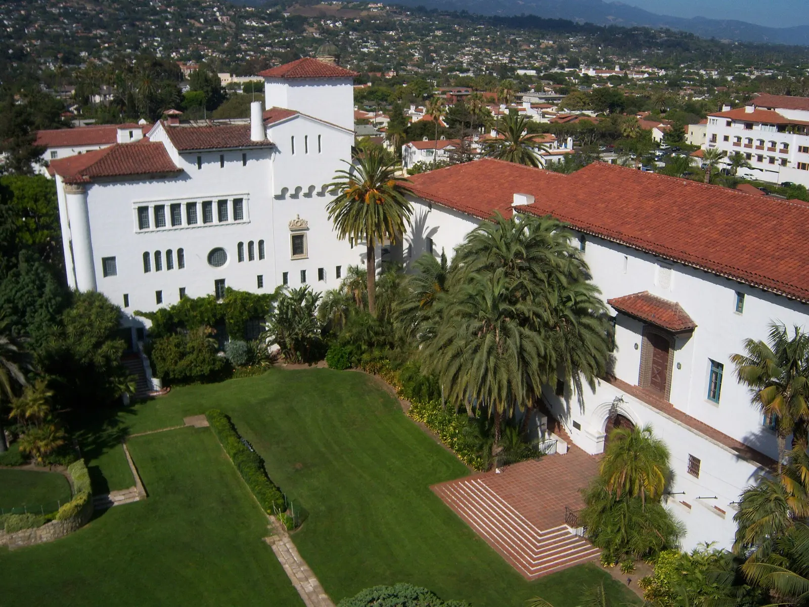 White Spanish Colonial Revival courthouse with red tile roofs and a clock tower, Santa Barbara, California