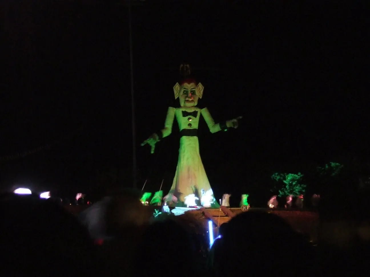 The towering figure of Zozobra illuminated at night above a large crowd, Santa Fe, New Mexico