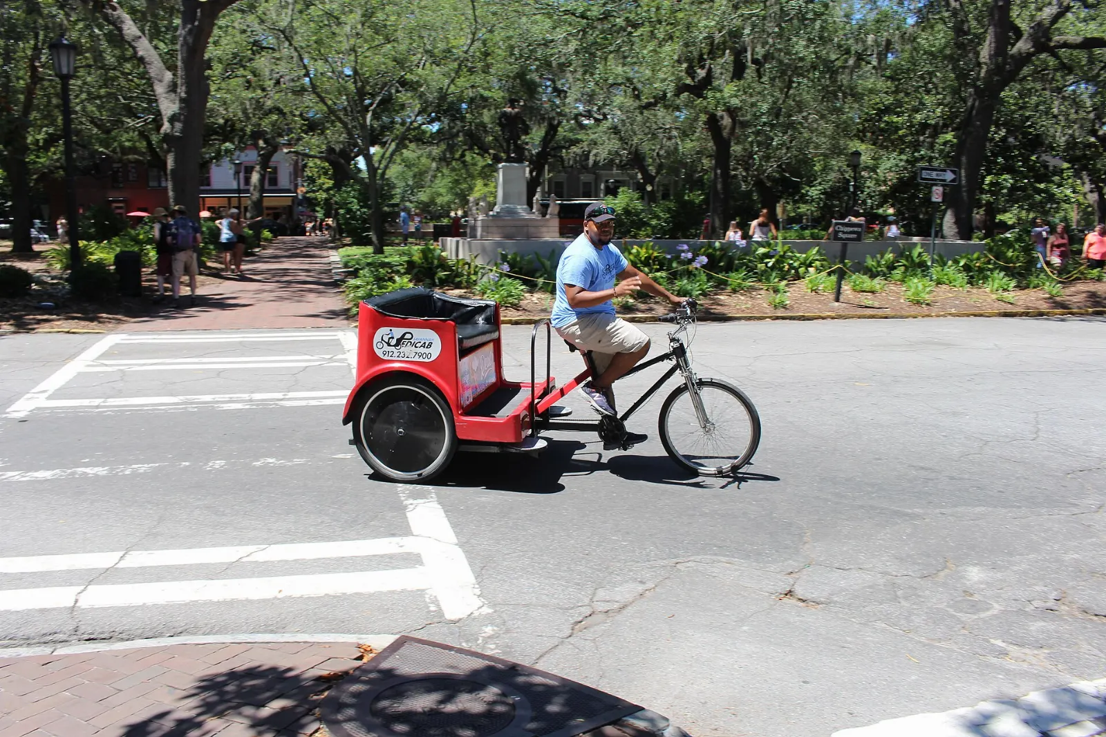 A shaded square in Savannah's Historic District with a bronze statue and live oaks, Georgia