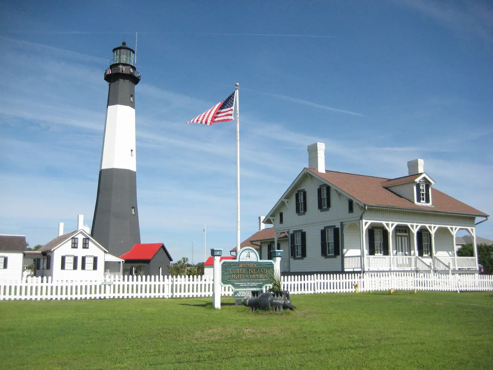 The black and white Tybee Island lighthouse with its keepers' cottages, Savannah, Georgia