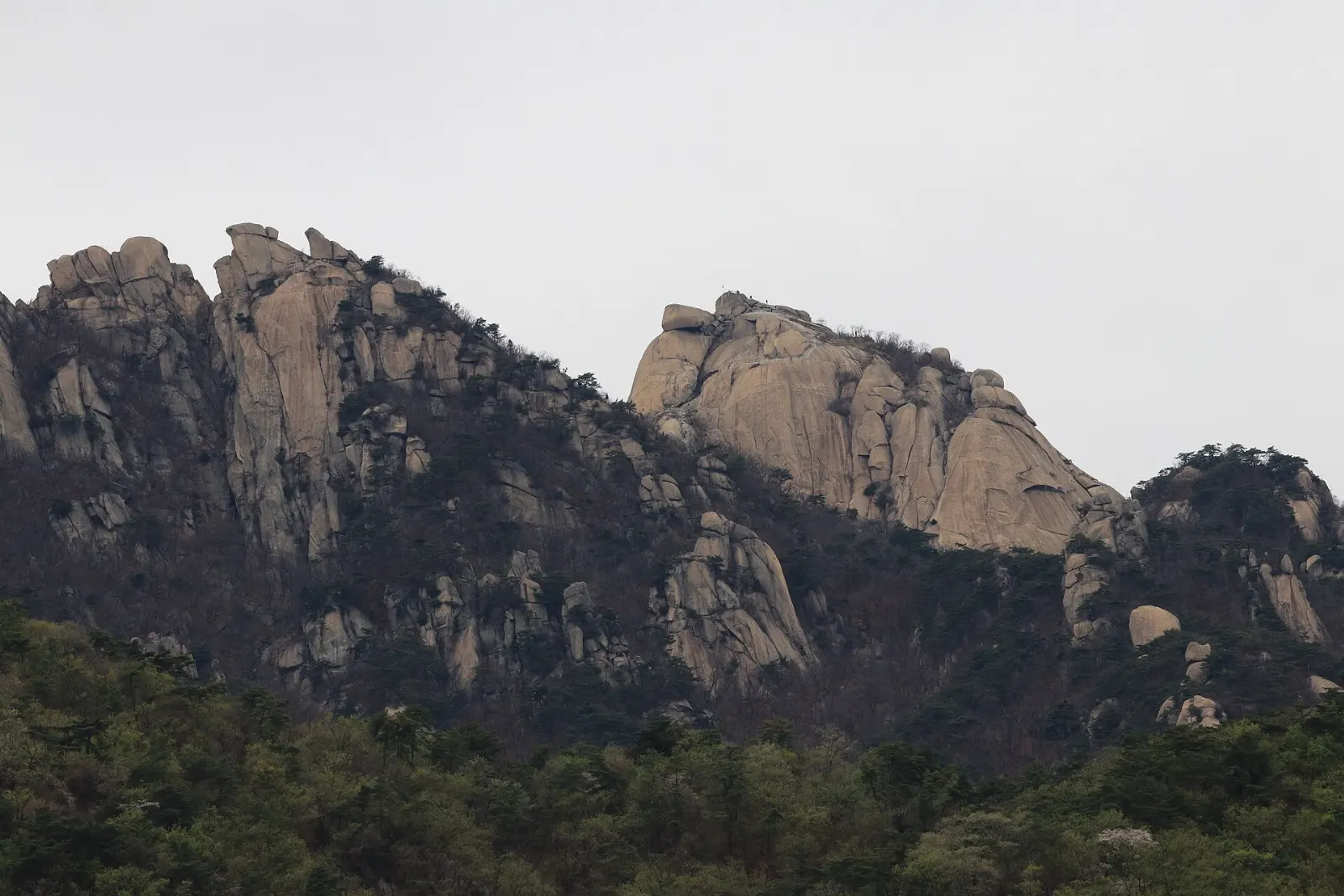 Granite peaks of Bukhansan with hikers on the ridge above Seoul, South Korea
