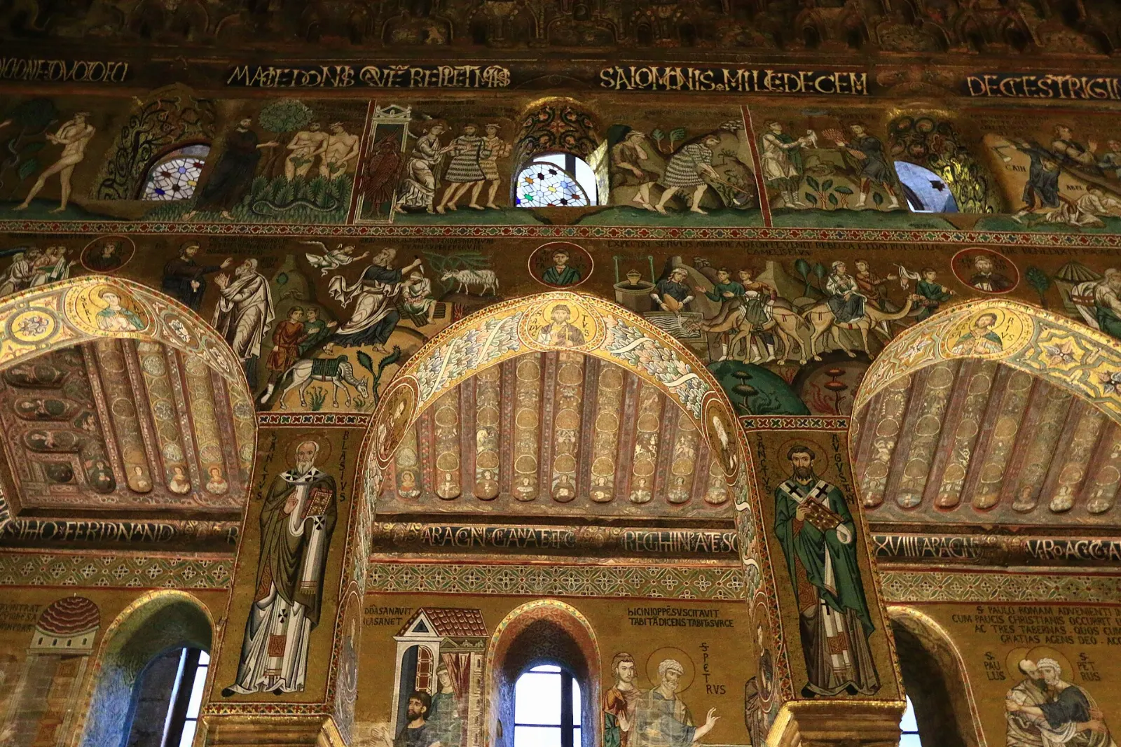 Golden Byzantine mosaics and a carved wooden ceiling inside a royal chapel, Sicily, Italy