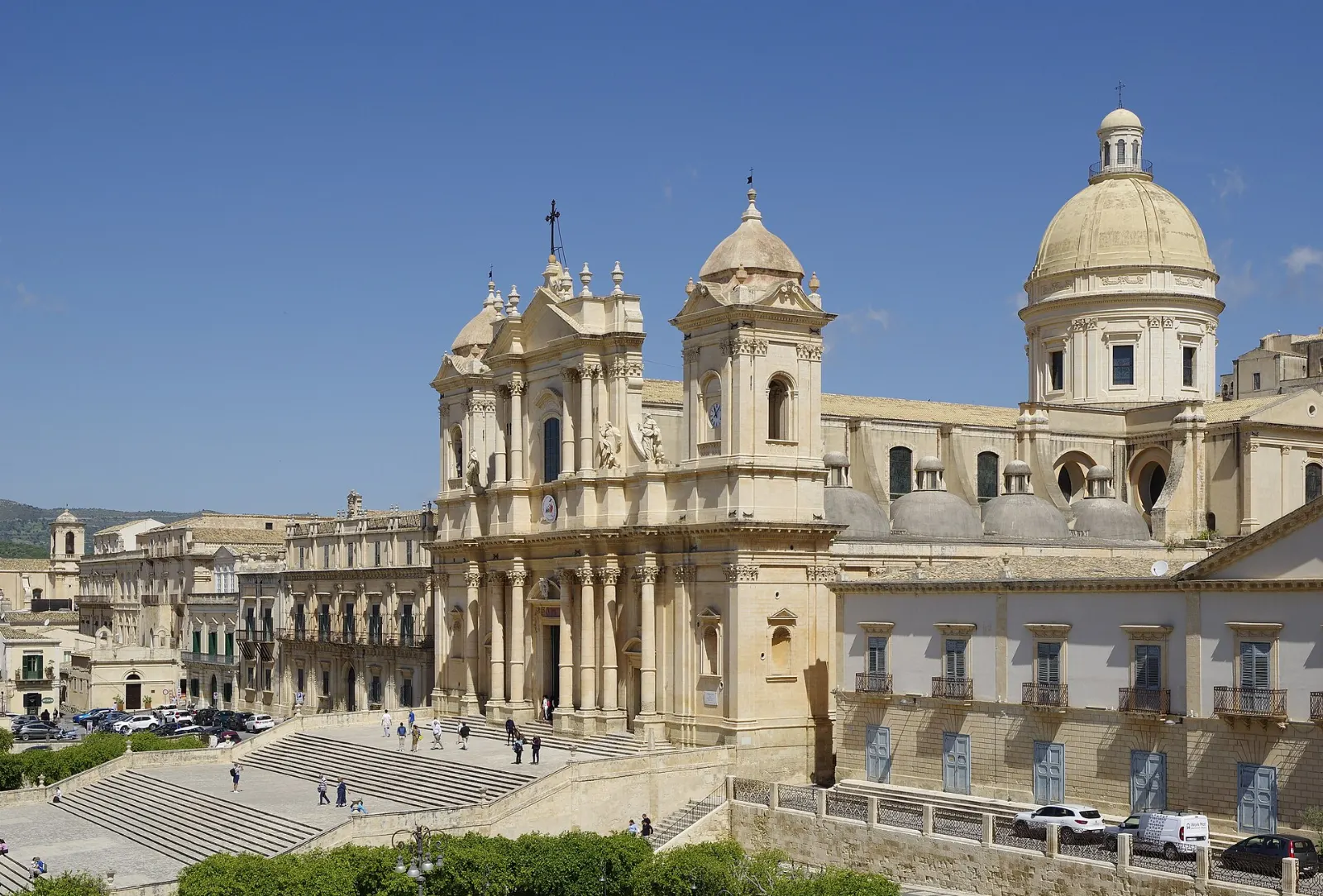 A honey-colored baroque cathedral at the top of a wide staircase, Sicily, Italy