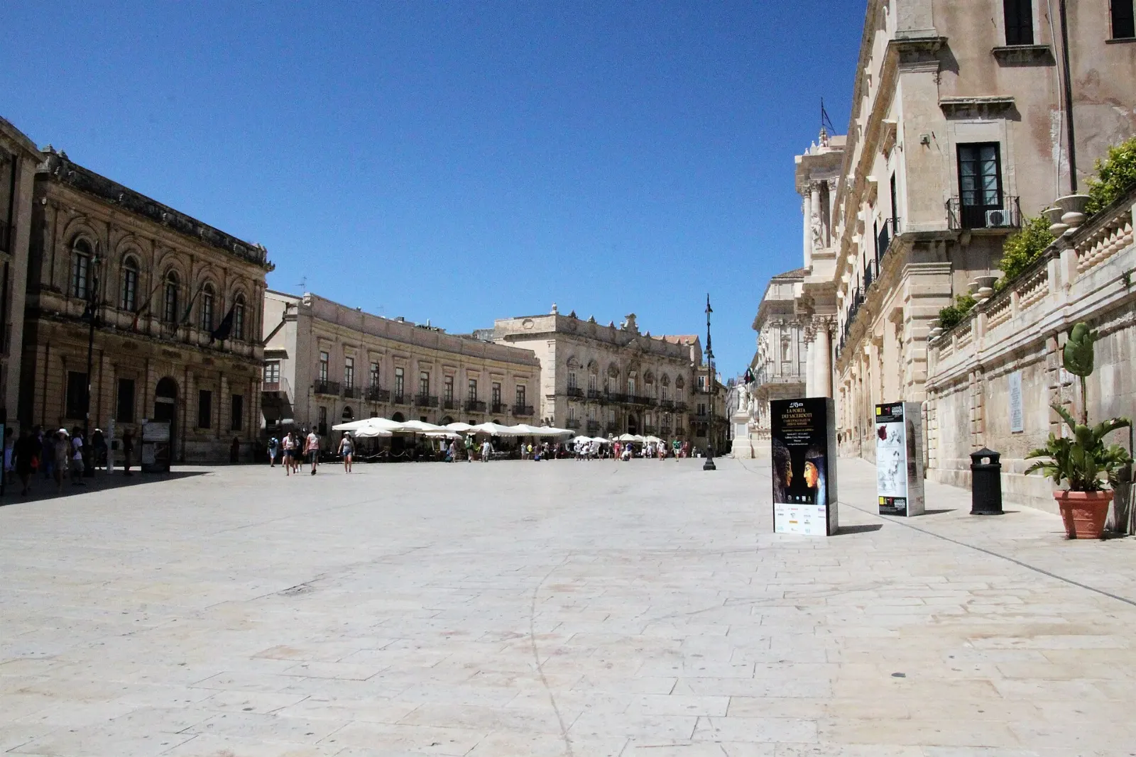 A pale stone square lined with baroque facades on the island of Ortigia, Sicily, Italy