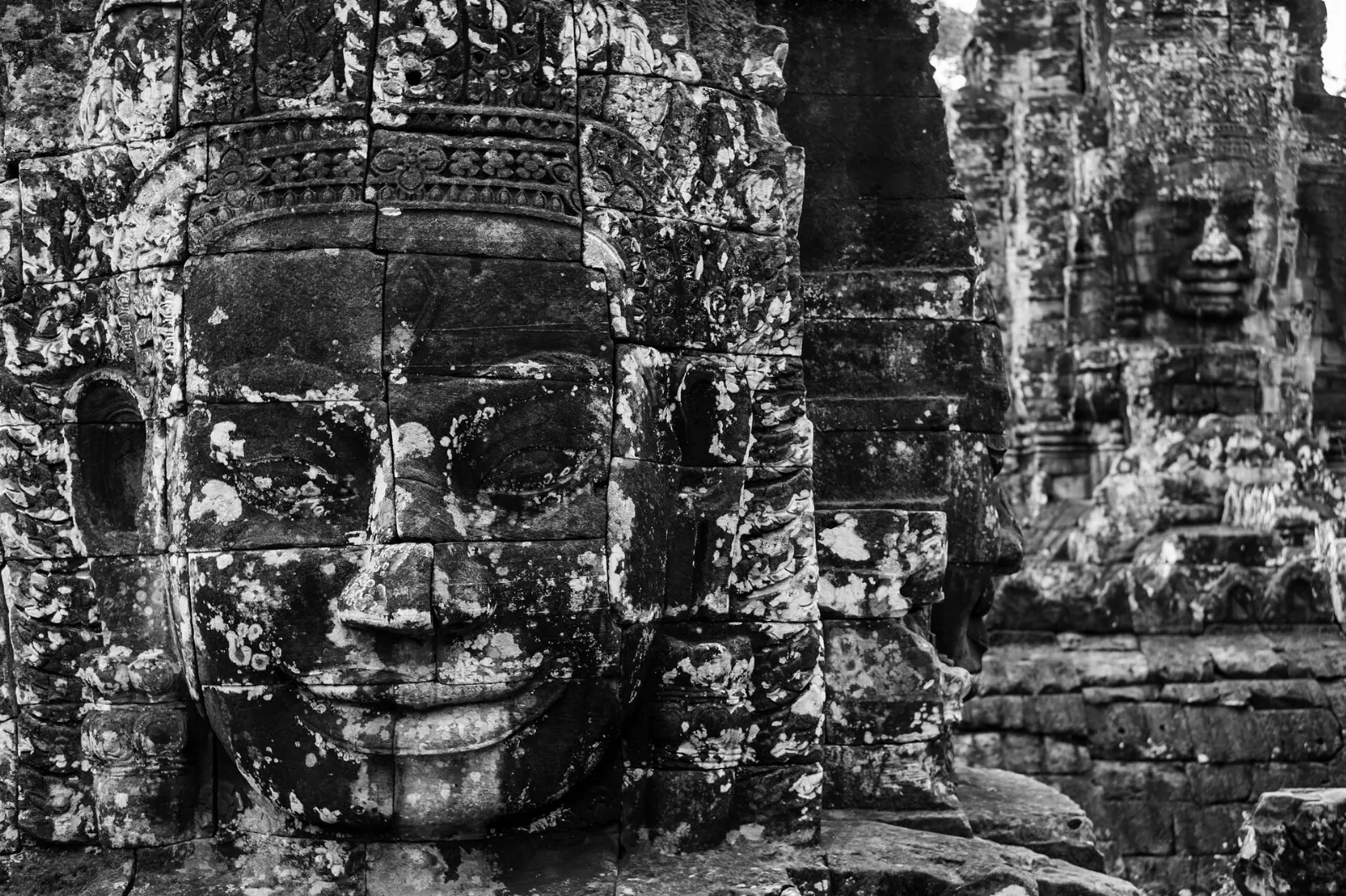 Serene carved stone faces on the towers of the Bayon temple, Siem Reap and Angkor, Cambodia