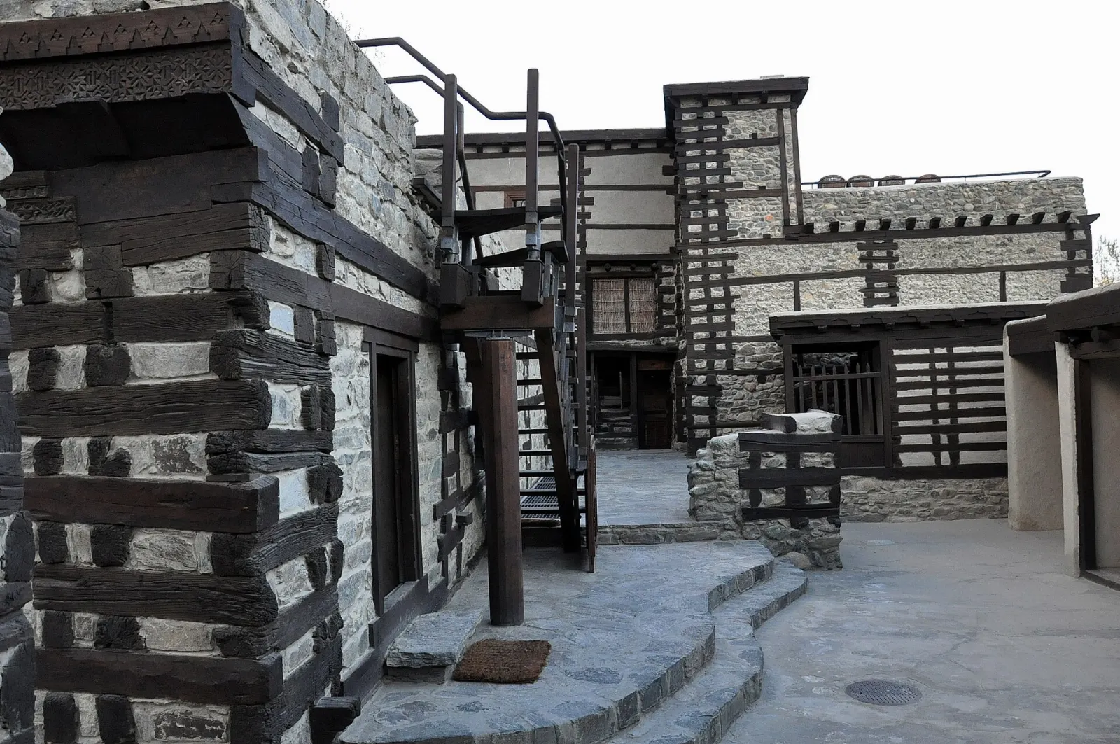 The restored wooden and stone Shigar Fort palace beside a stream and orchards, Skardu, Pakistan