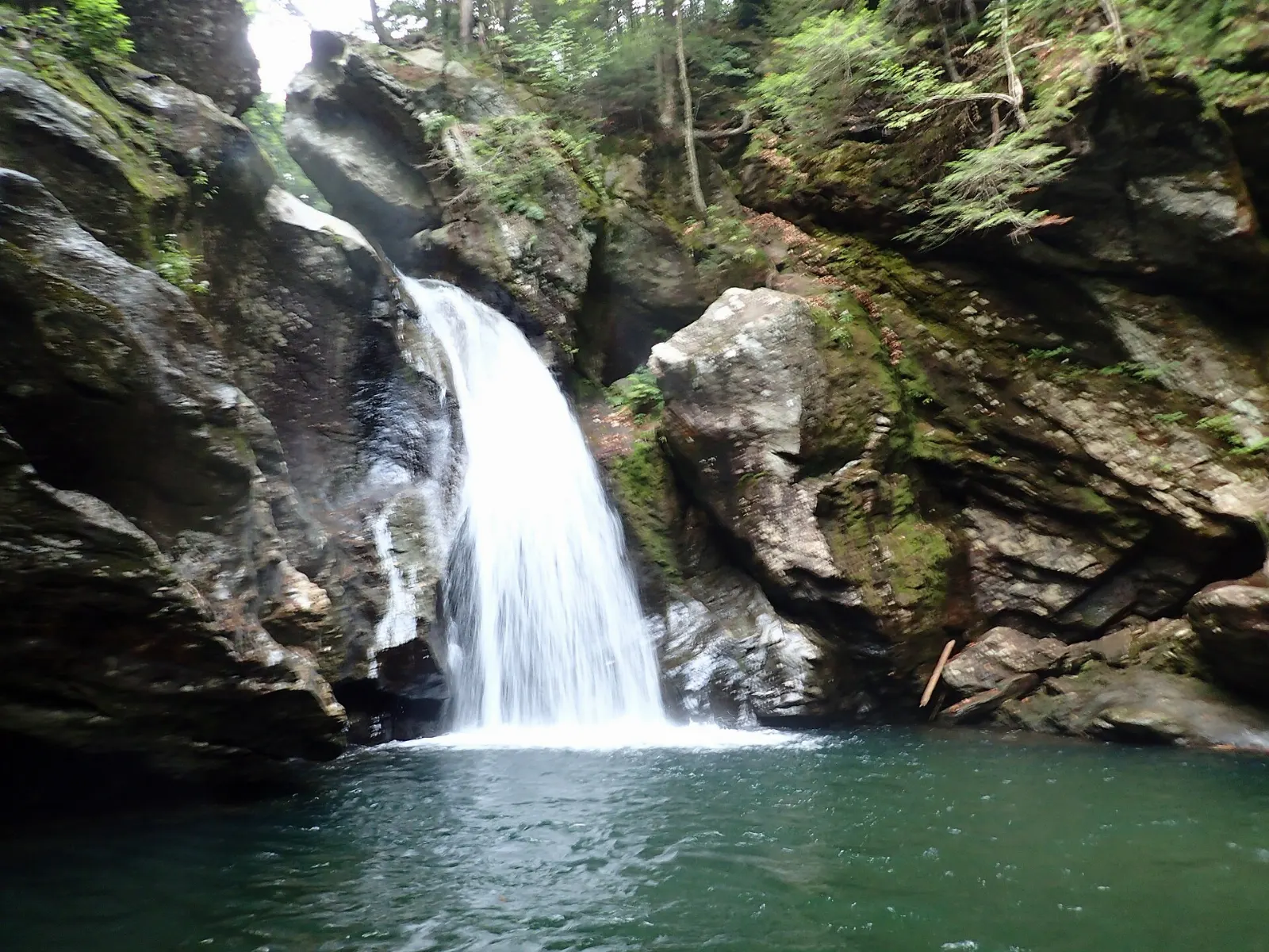Water pouring through a narrow rock gorge at Bingham Falls, Stowe, Vermont