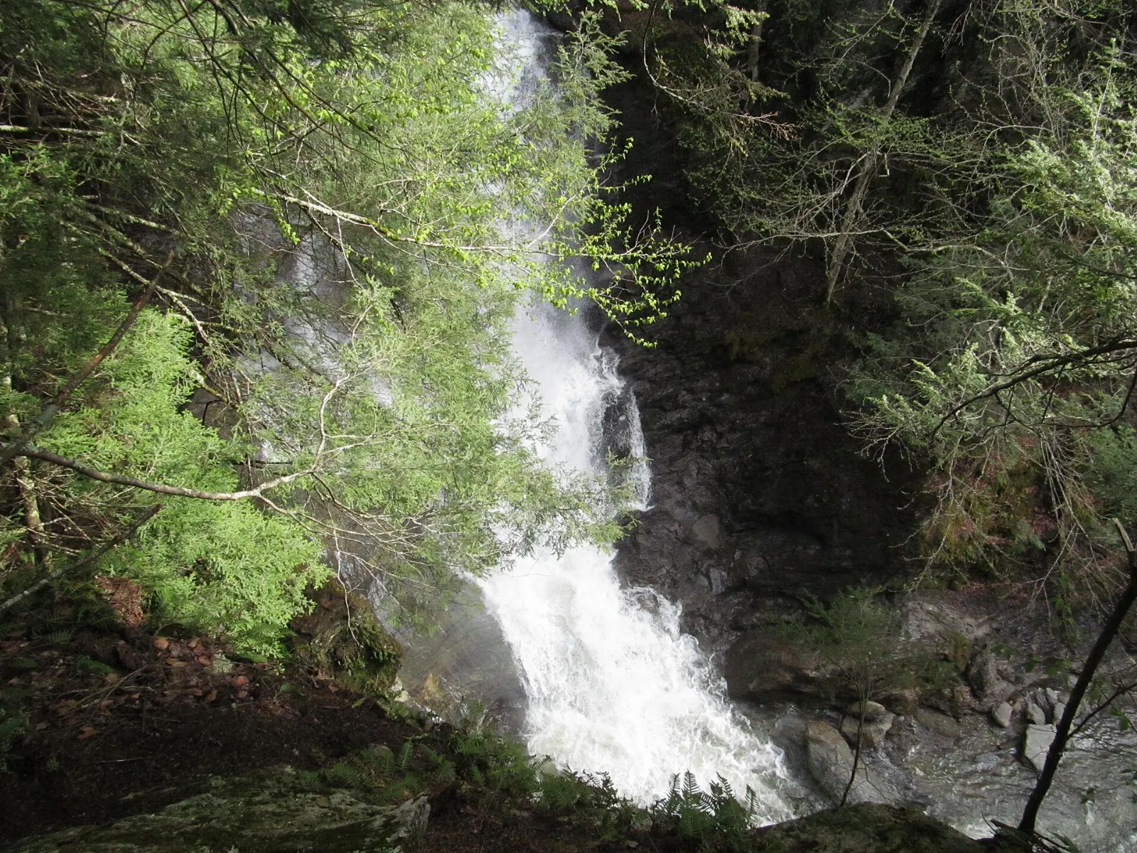 Tall cascade spilling over ledges at Moss Glen Falls, Stowe, Vermont