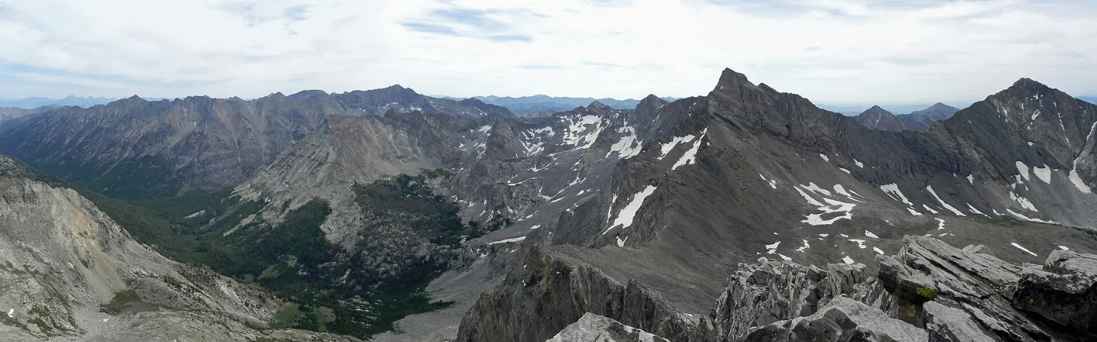 A small log cabin on a high ridge with the Pioneer Mountains behind it, Sun Valley, Idaho