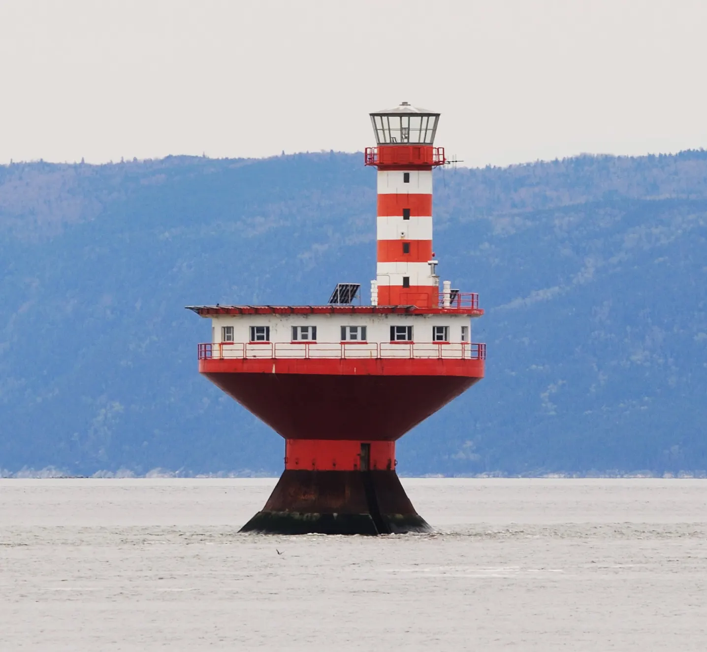 The Prince Shoal lighthouse rising from the St. Lawrence near Tadoussac, Quebec