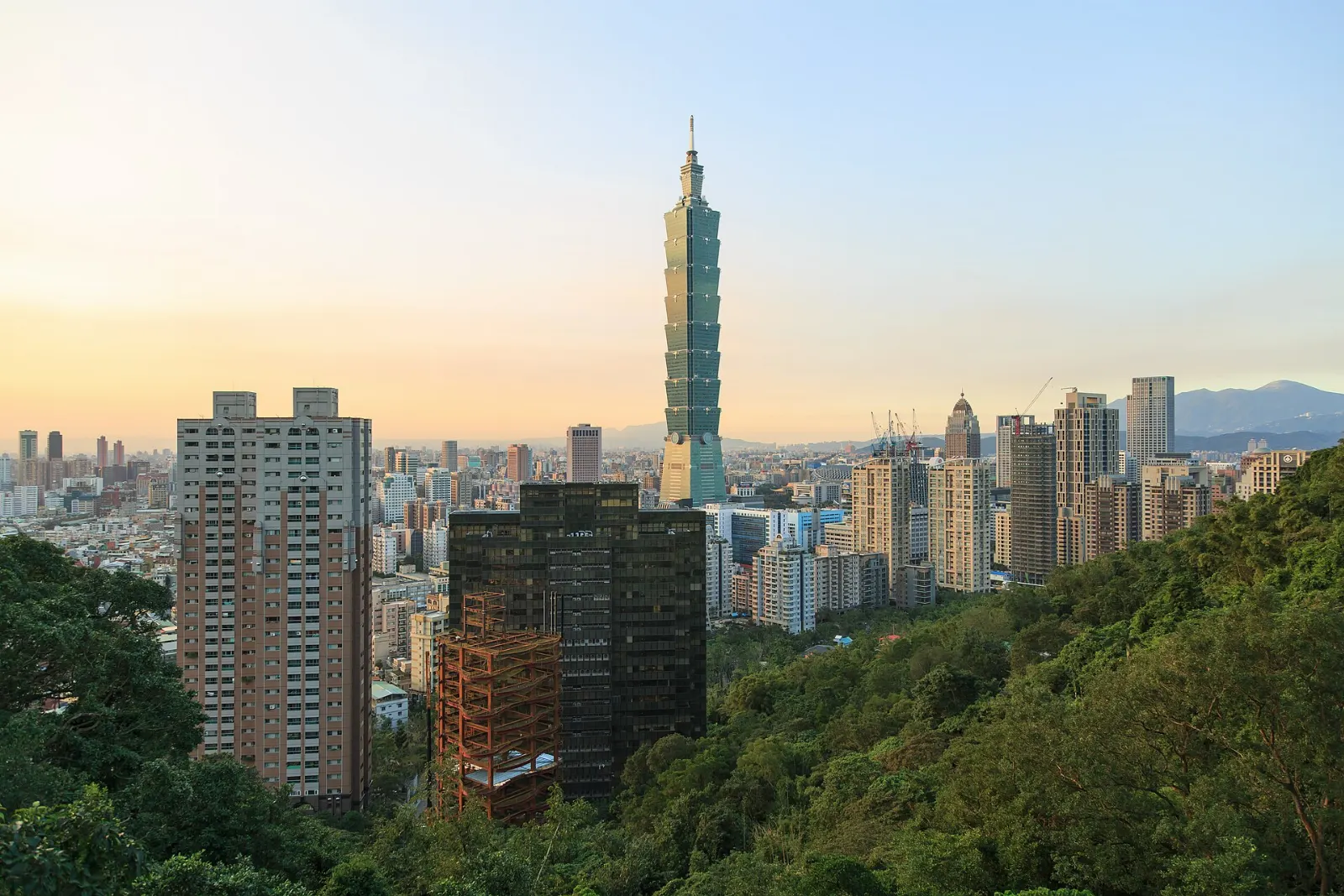 Segmented glass and steel tower of Taipei 101 against a blue sky, Taiwan