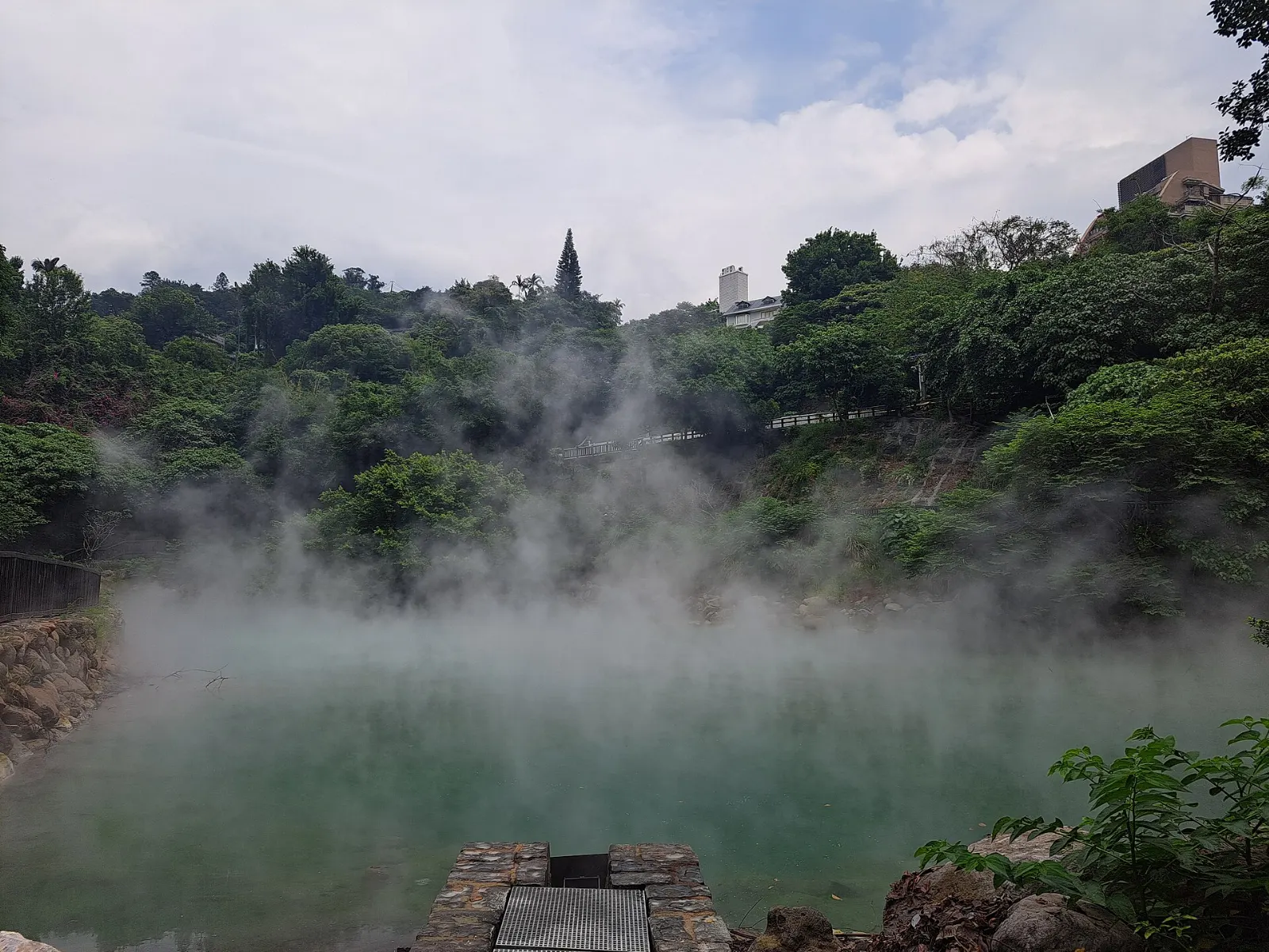 Steam rising from the pale green waters of Beitou Thermal Valley, Taipei, Taiwan