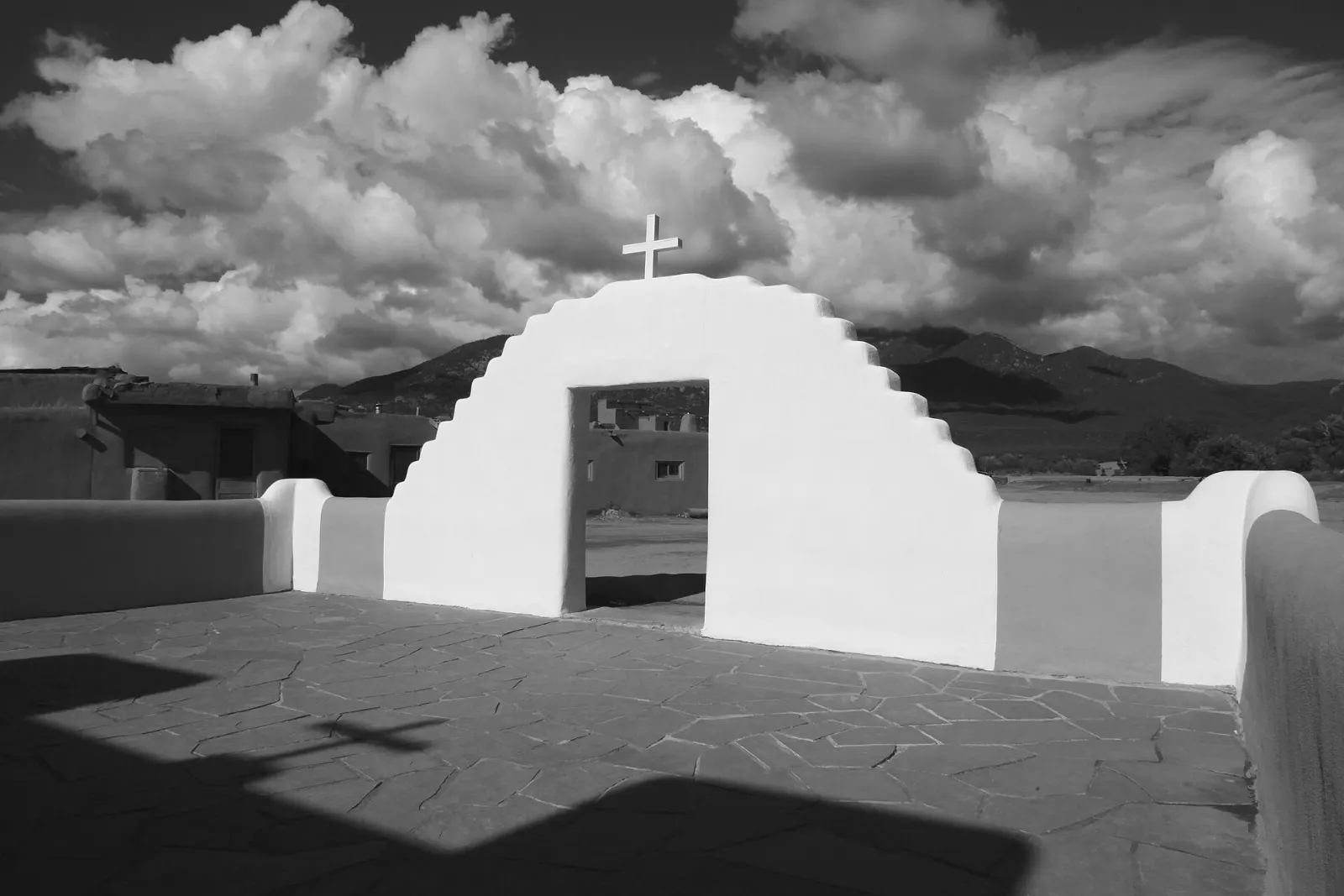 The white adobe San Geronimo Chapel with twin bell towers at Taos Pueblo, New Mexico