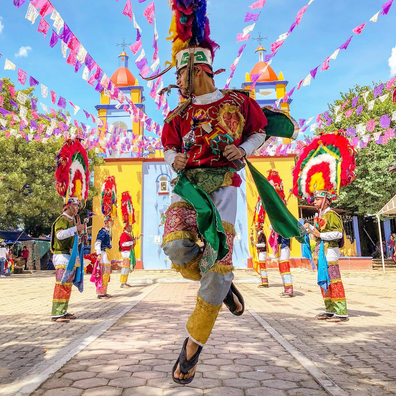 Dancers in tall feathered headdresses performing the Danza de la Pluma, Teotitlán del Valle, Oaxaca