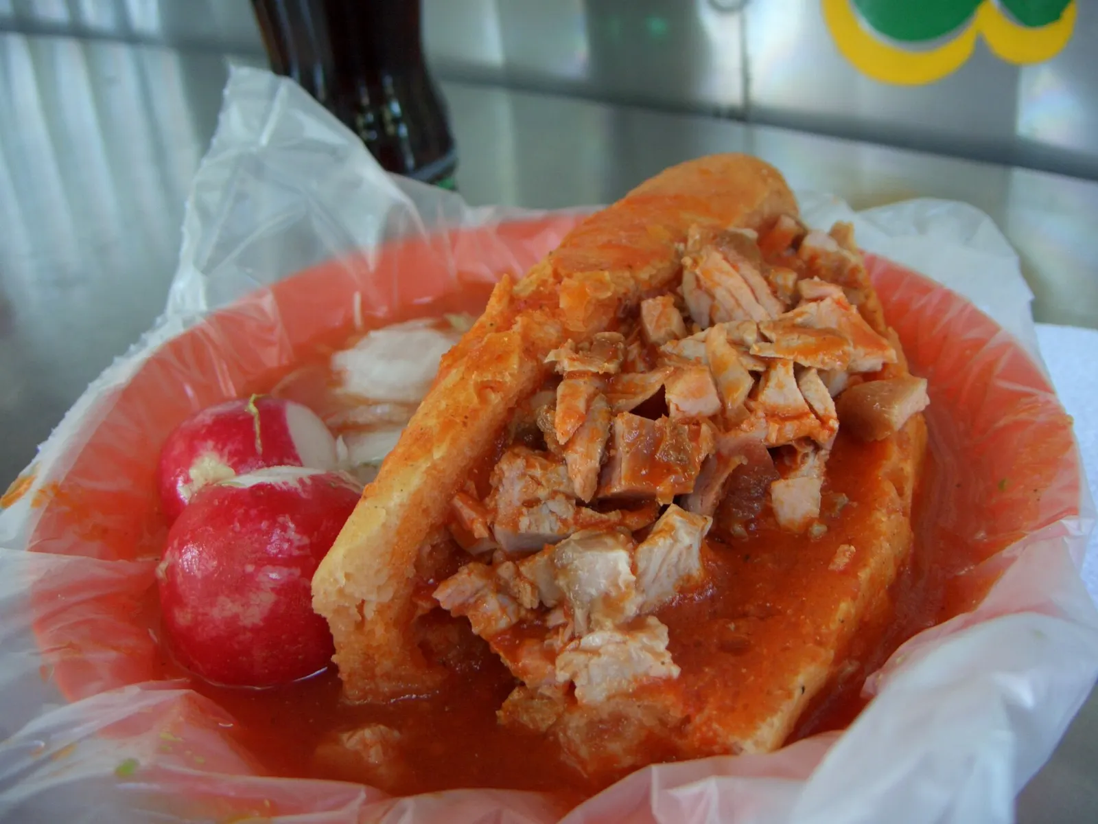 Torta ahogada sandwich covered in red chile sauce, Tlaquepaque, Jalisco
