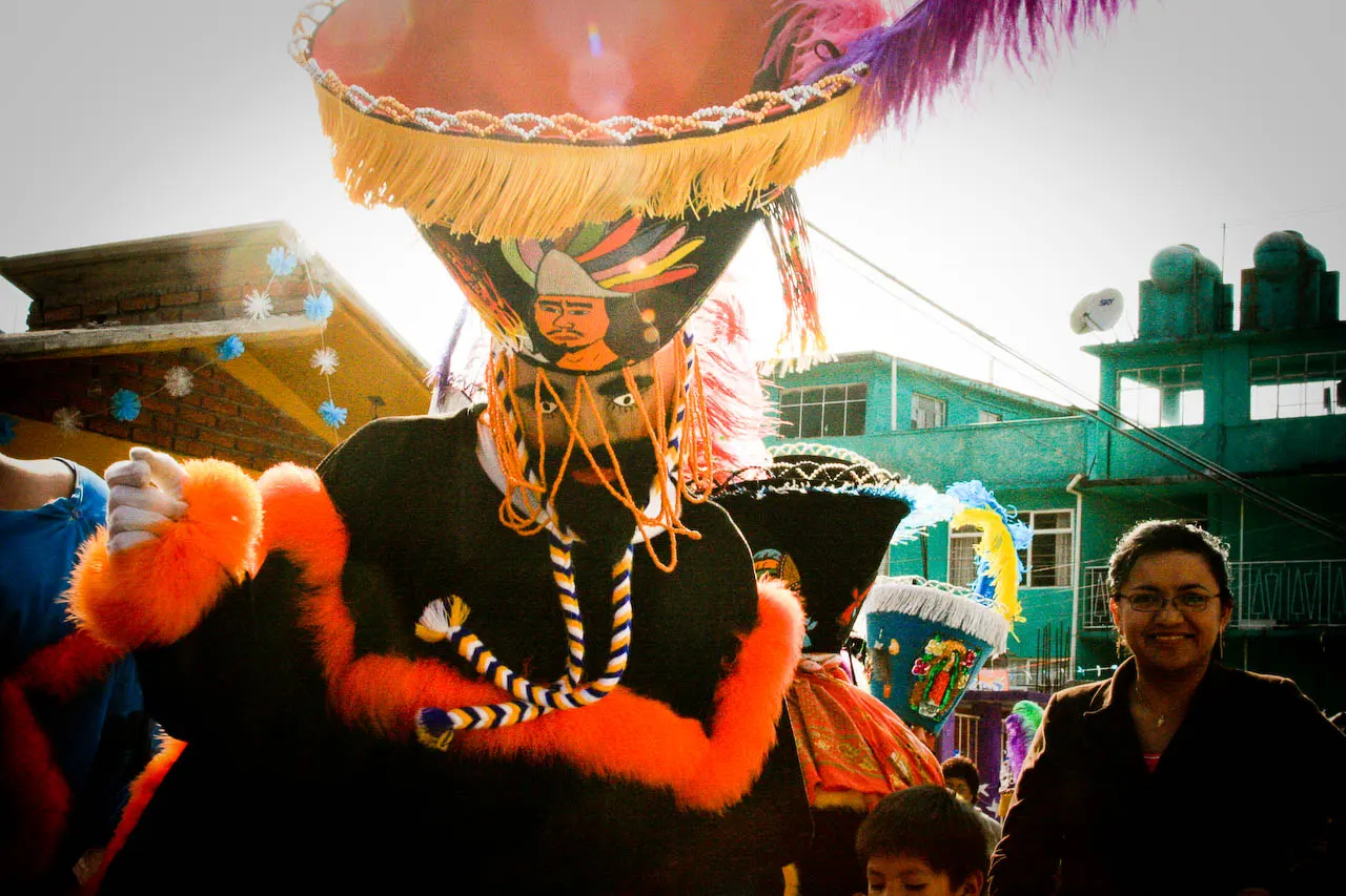 Chinelos dancers in feathered hats and long embroidered robes during carnival, Tlayacapan, Morelos