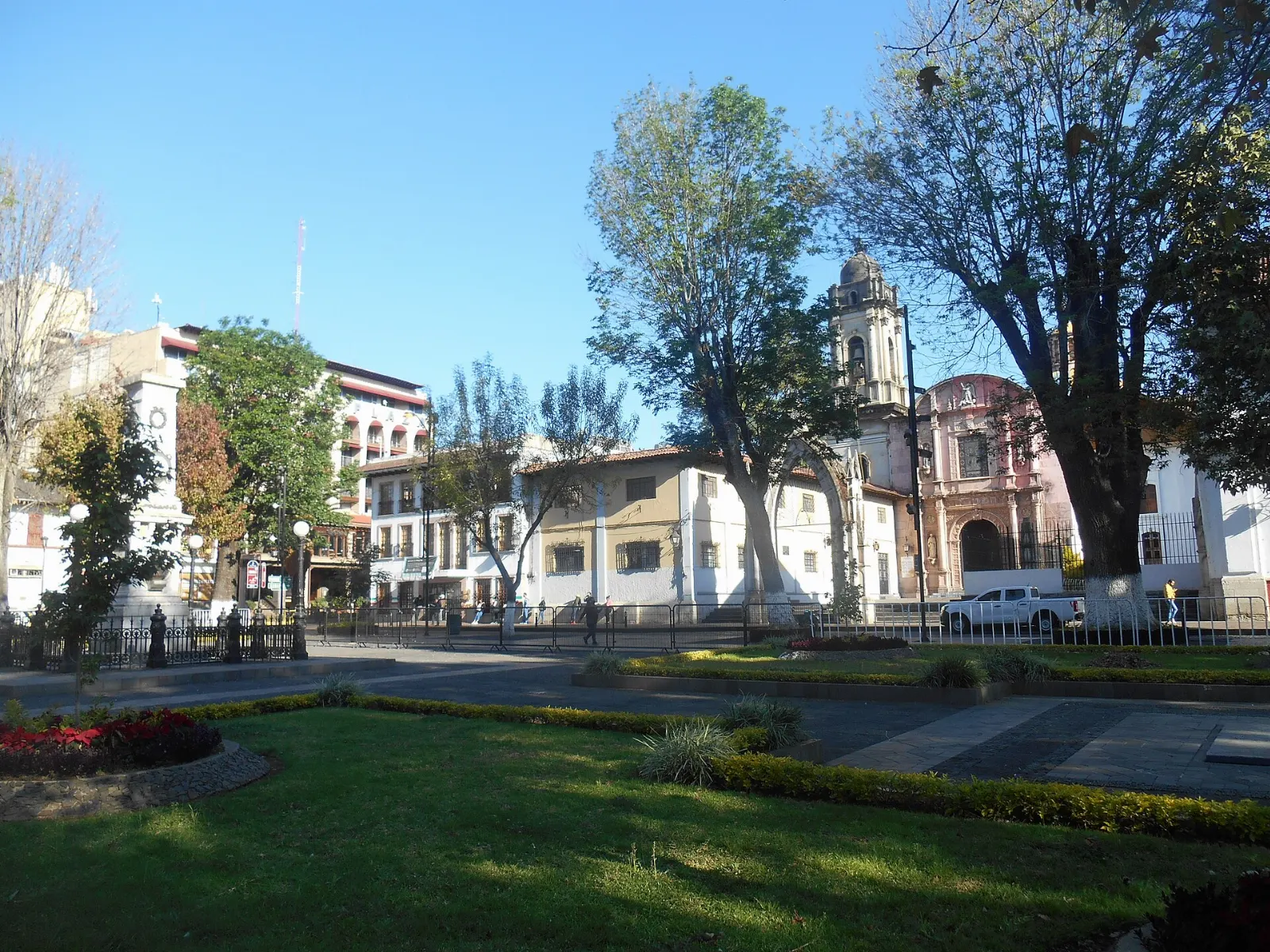 The long main plaza of Uruapan with trees and colonial arcades, Michoacán