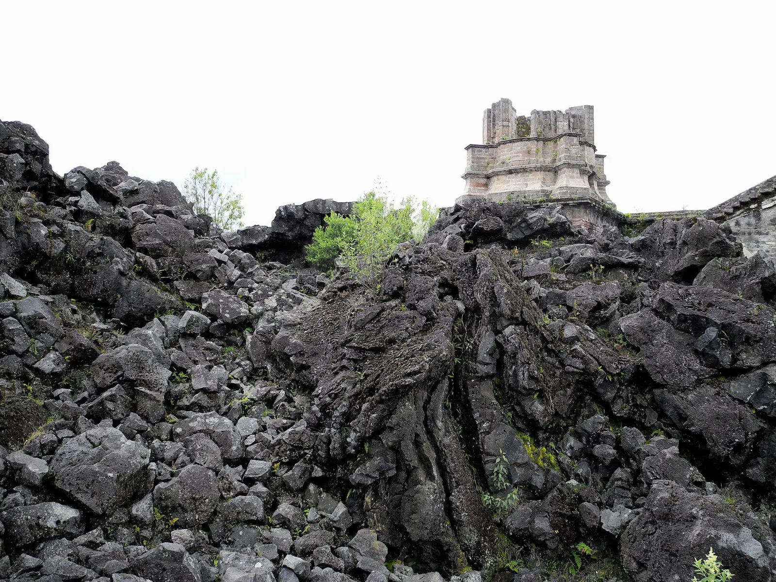 Church tower rising from black lava near Parícutin volcano, Uruapan, Michoacán