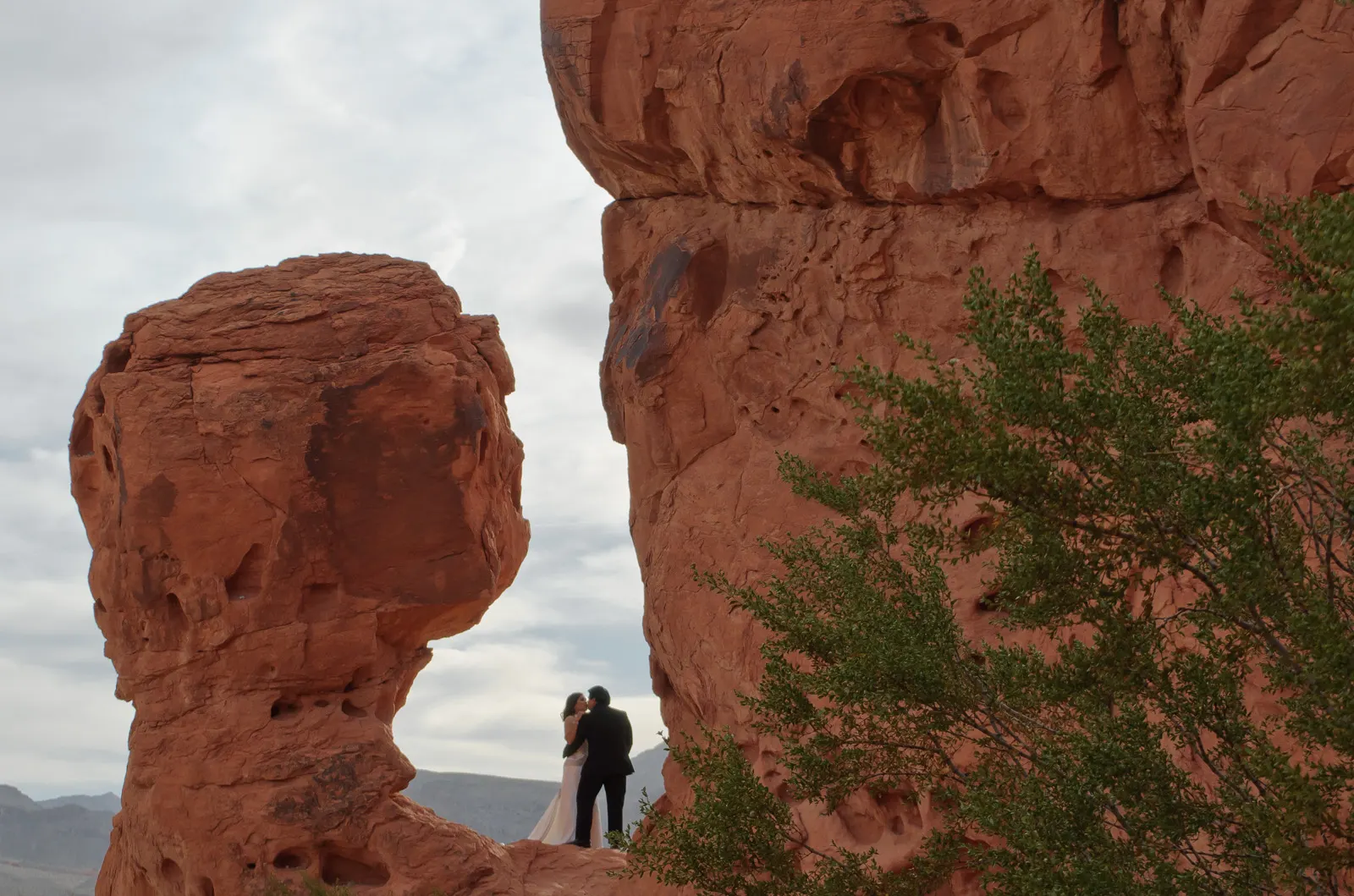 A group of red sandstone towers standing in the desert beside a road, Valley of Fire State Park, Nevada