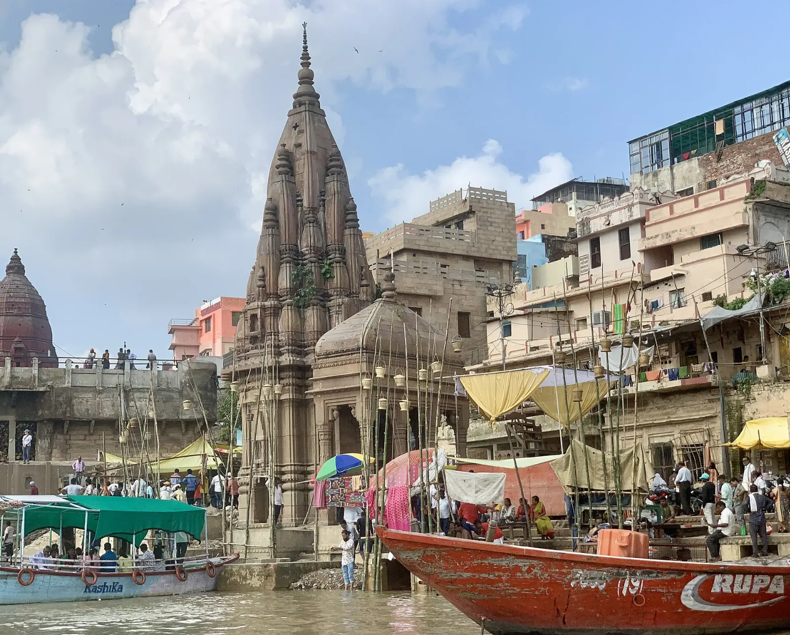 Smoke rising from Manikarnika Ghat beside stacks of firewood on the Ganges, Varanasi, India