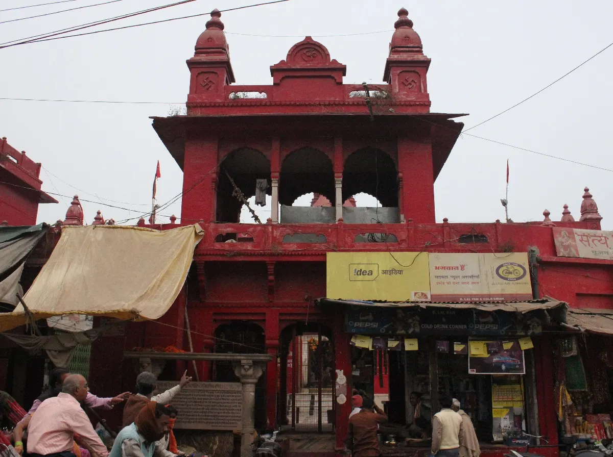 Red ochre Durga Temple beside its stepped water tank in Varanasi, India
