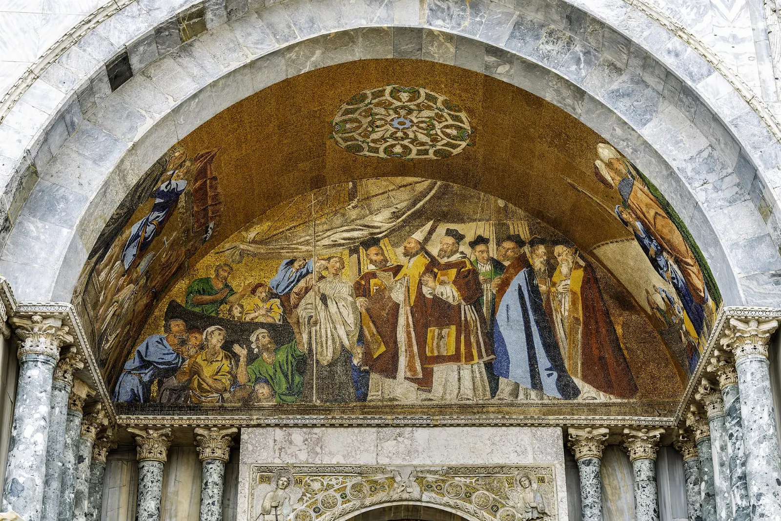 The domed facade of St Mark's Basilica with golden mosaics above its arches, Venice, Italy