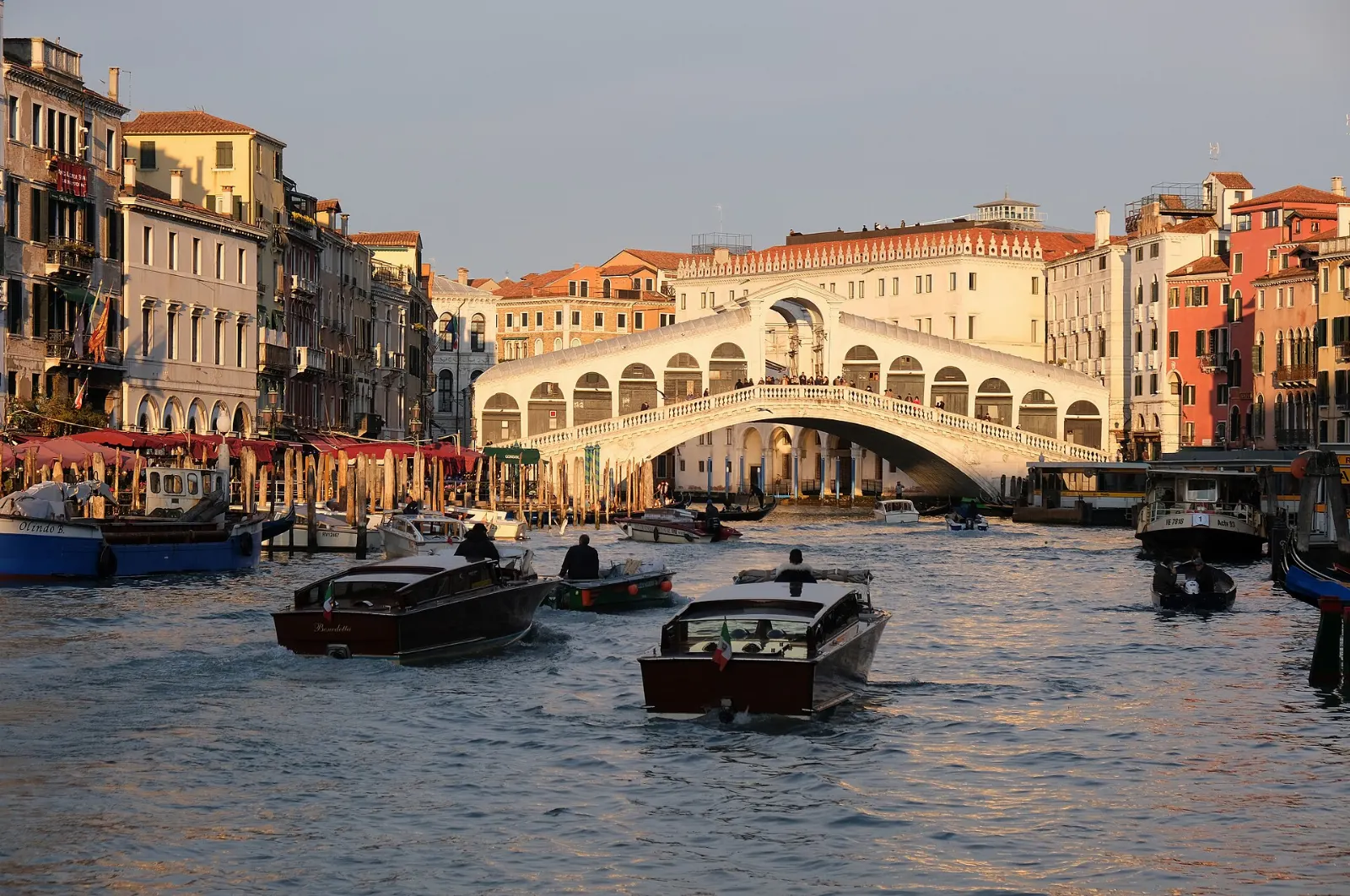 The stone arch of the Rialto Bridge over the Grand Canal with boats below, Venice, Italy
