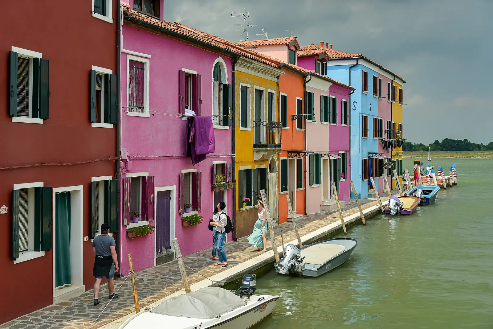 Brightly painted houses lining a canal on the island of Burano, Venice, Italy