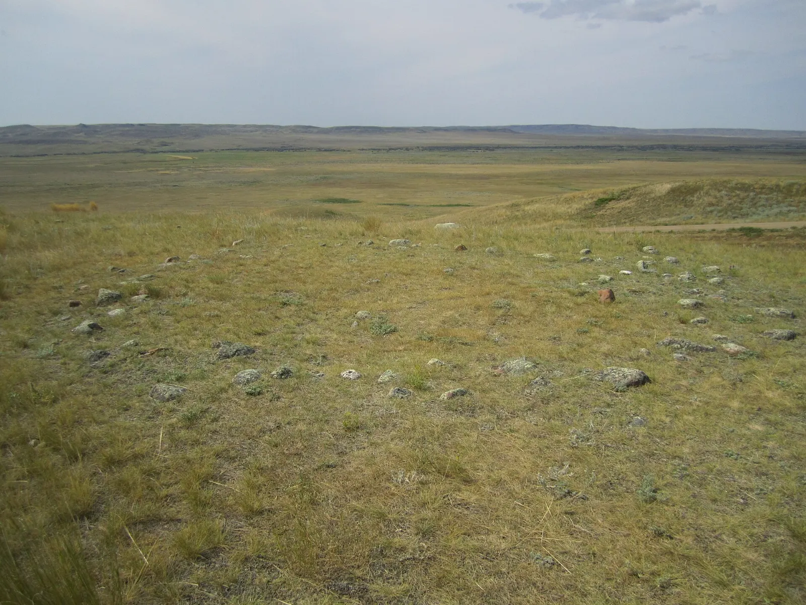 Circle of stones marking an old tipi ring on the prairie, Wanuskewin Heritage Park, Saskatchewan