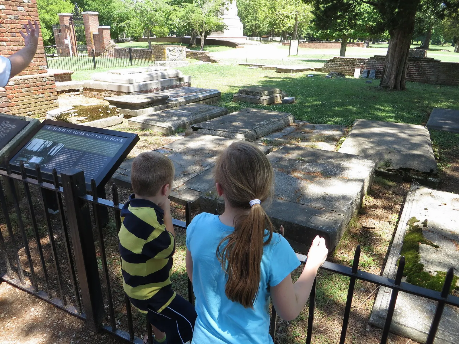 A ruined seventeenth-century brick church tower beside a memorial church at Jamestown, Williamsburg, Virginia